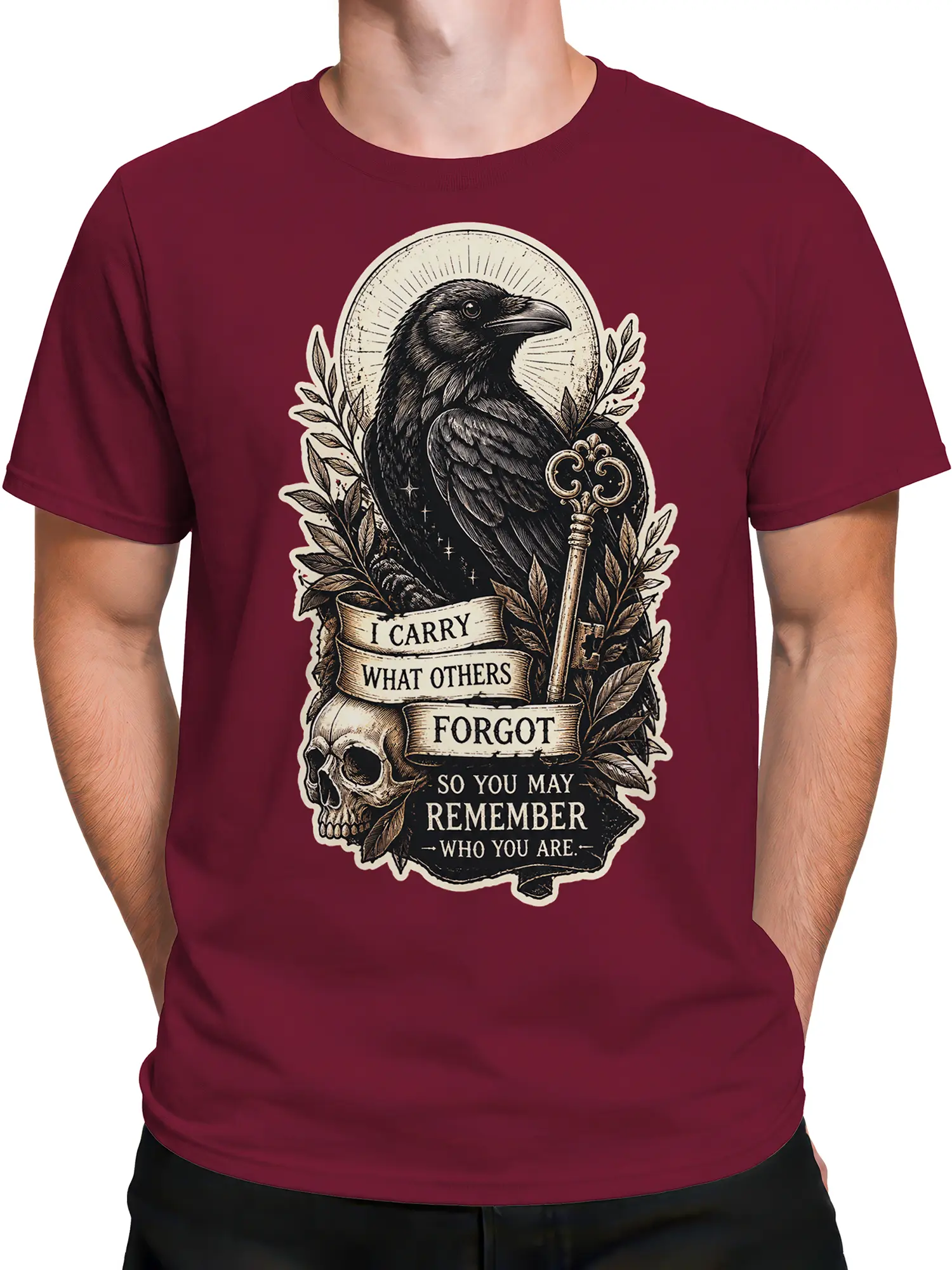 Male torso wearing burgundy T-shirt with raven, skull, ornate key, and remembrance artwork
