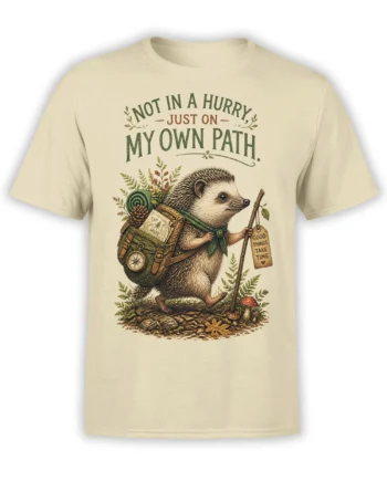 Beige hedgehog wanderer T-shirt with backpack, walking stick, woodland details, and an own-path message