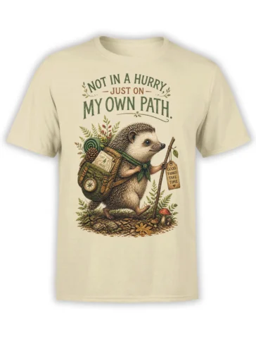 Beige hedgehog wanderer T-shirt with backpack, walking stick, woodland details, and an own-path message