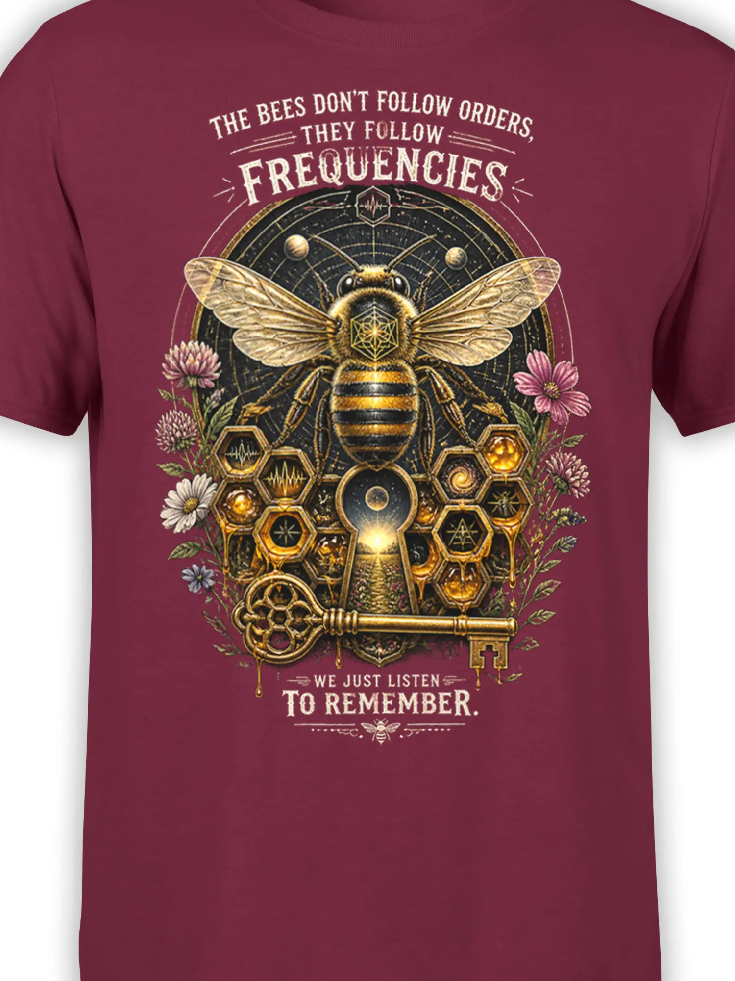 Close-up of honey bee artwork with geometric symbols, floral details, and frequency text on burgundy fabric