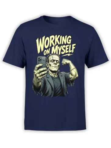 Stitched monster holding a smartphone and flexing on a navy T-shirt with yellow “WORKING ON MYSELF” text