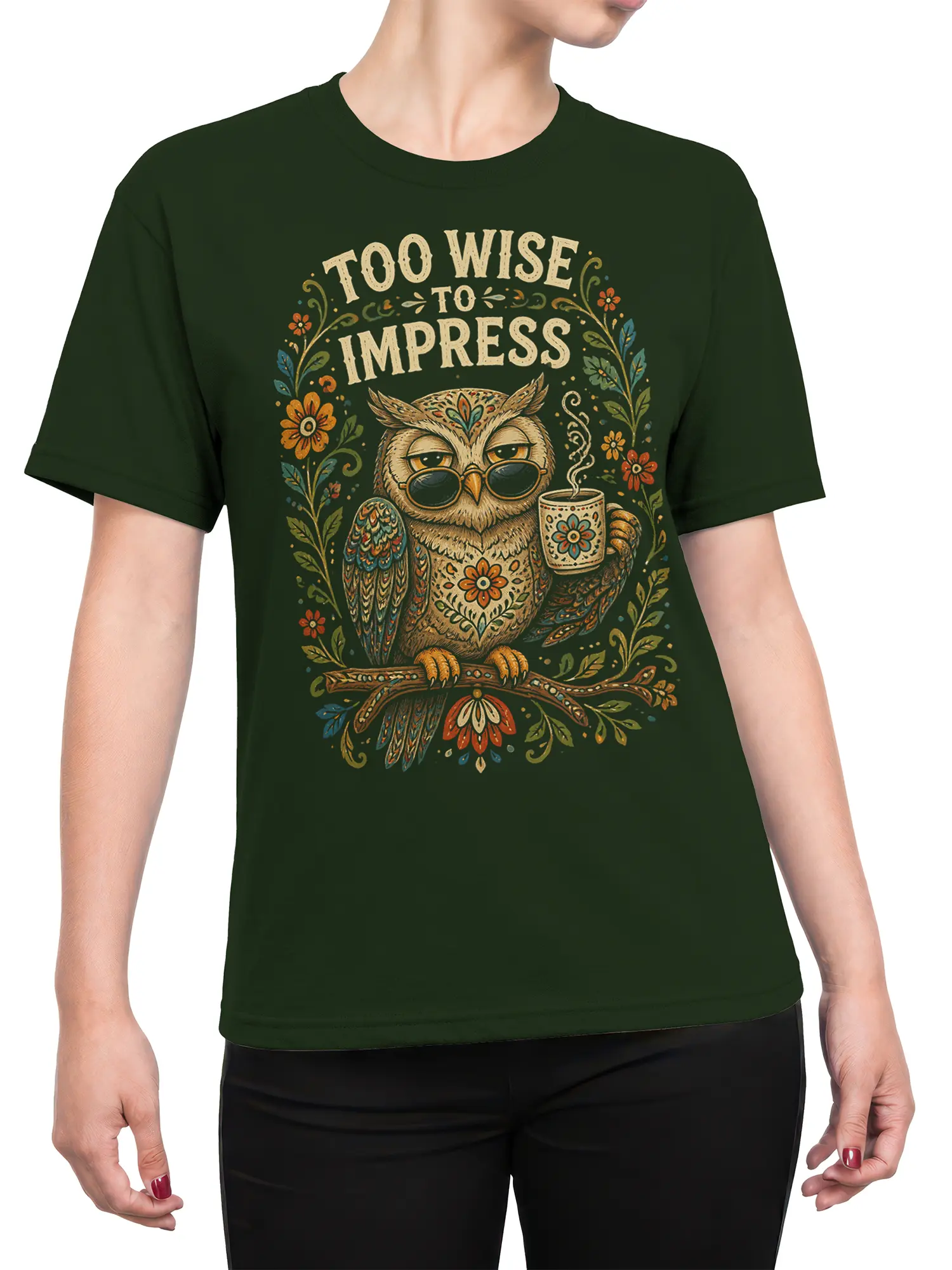 Female torso wearing a dark green owl graphic tee with floral artwork, glasses, mug, and Too Wise to Impress text