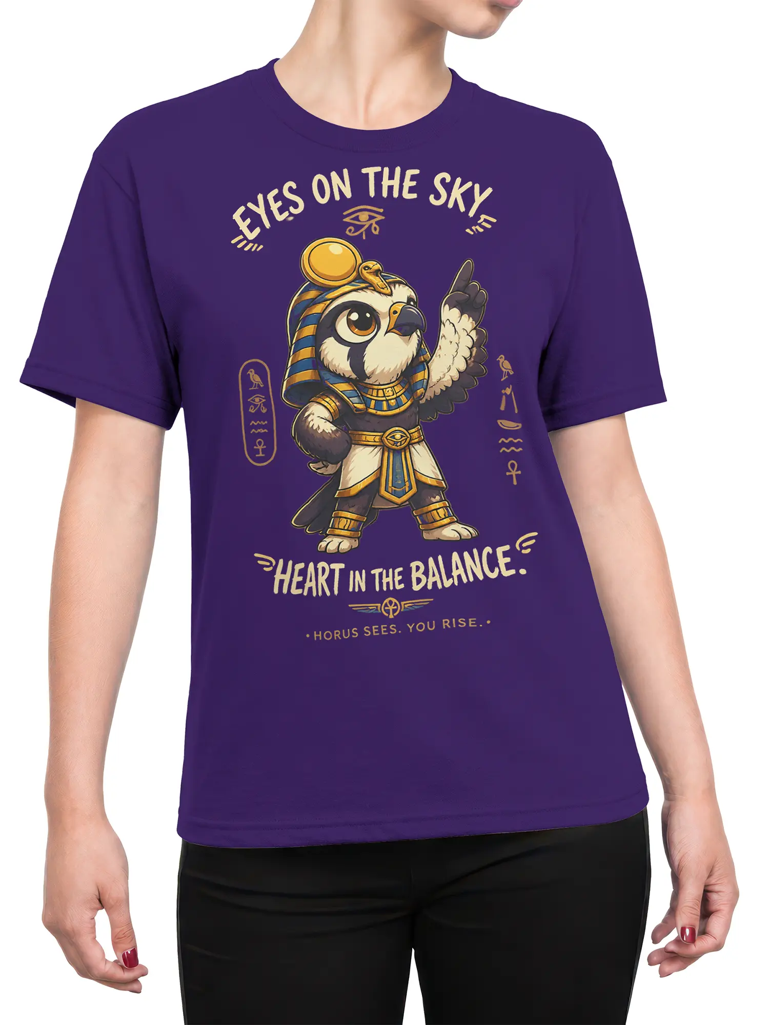 Female torso wearing a purple Egyptian falcon deity T-shirt with gold symbols and balanced heart lettering