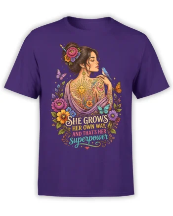 Purple T-shirt with a floral woman portrait, butterflies, blue bird, sun, and “She Grows Her Own Way” lettering