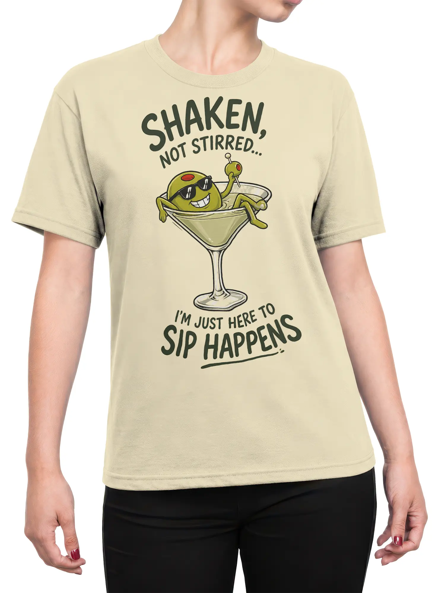 Female torso wearing a beige martini T-shirt with a cartoon olive in sunglasses and playful “Sip Happens” text