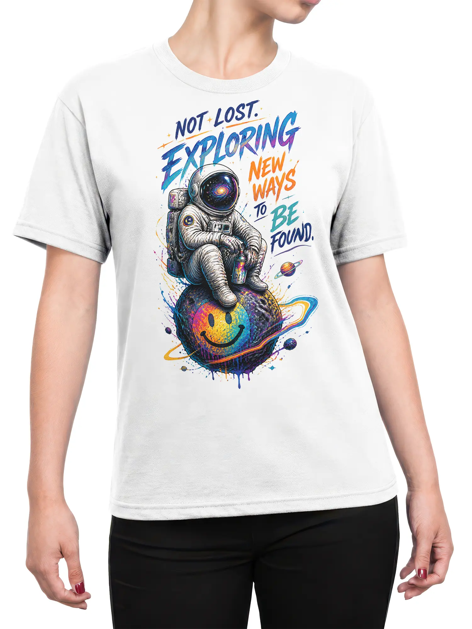 Female torso wearing a white astronaut graphic tee with a colorful smiling planet and cosmic explorer message