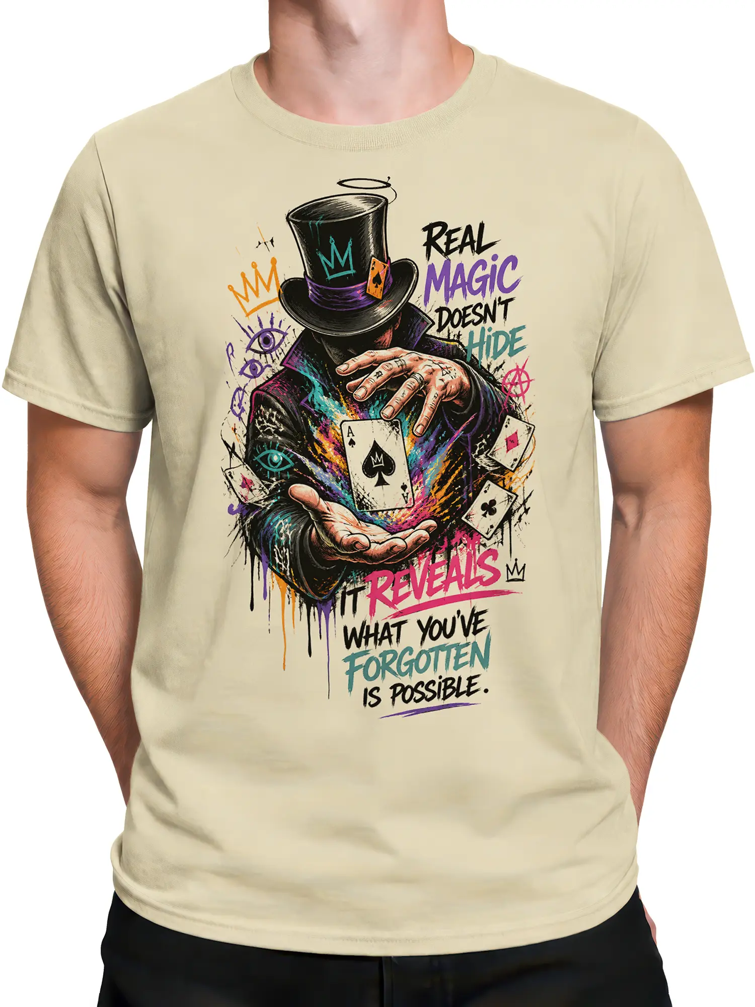 Male torso wearing a beige magician T-shirt with colorful top hat, playing cards, and surreal artwork