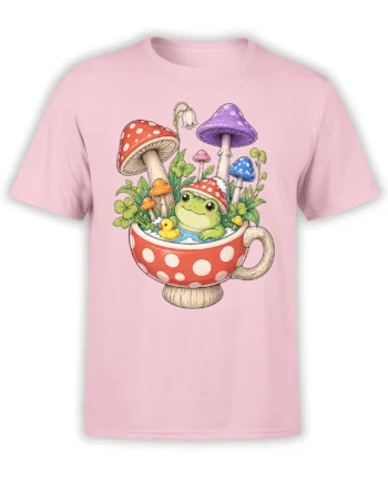 Pink T-shirt with a whimsical green frog in a mushroom teacup, surrounded by colorful mushrooms and clovers