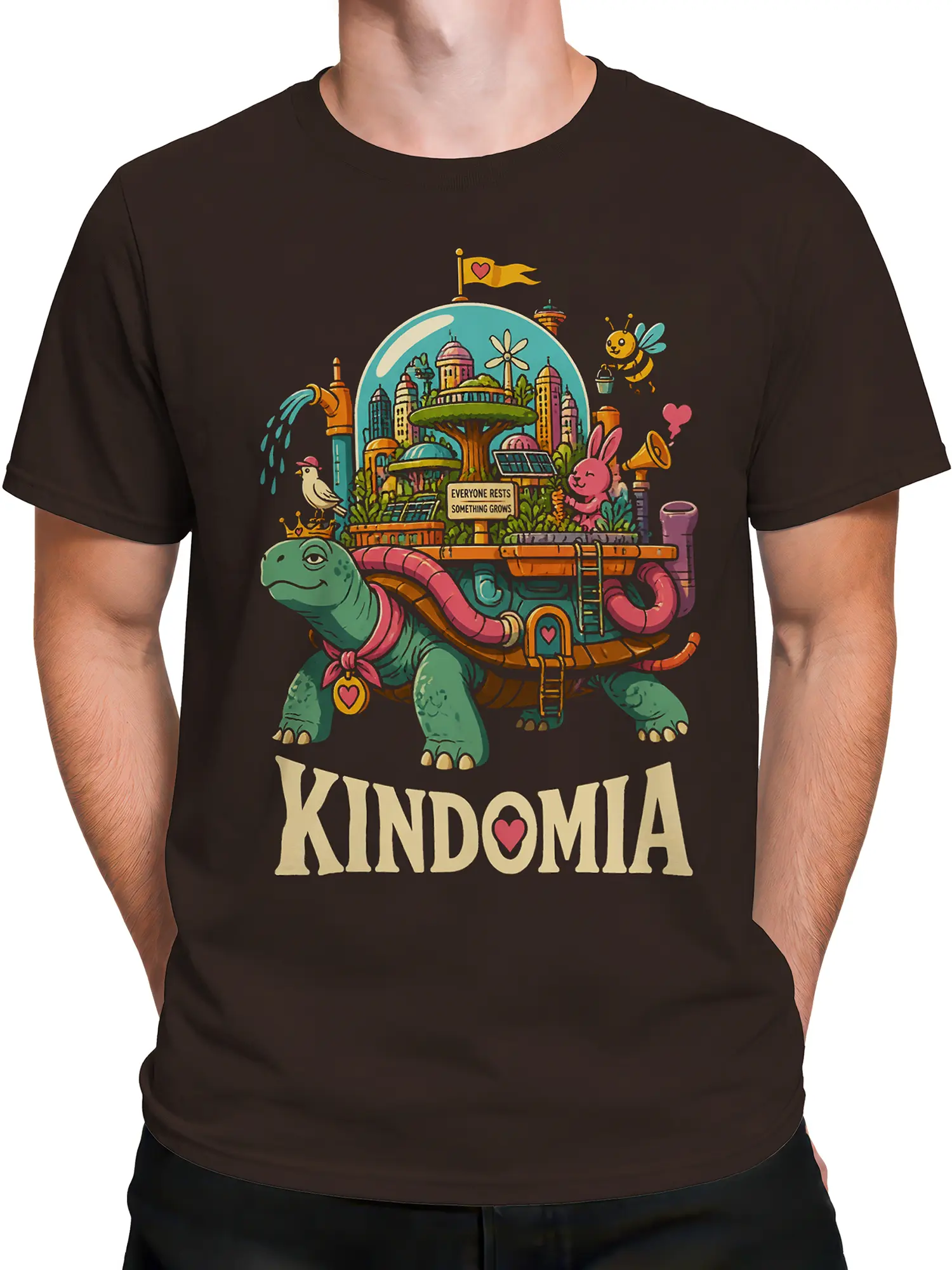 Male torso wearing a brown turtle t-shirt featuring a colorful city garden and KINDOMIA lettering