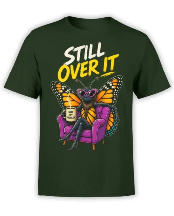 Green T-shirt with an unbothered butterfly in sunglasses, a purple armchair, mug, and “STILL OVER IT” text