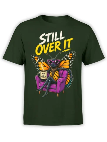Green T-shirt with an unbothered butterfly in sunglasses, a purple armchair, mug, and “STILL OVER IT” text