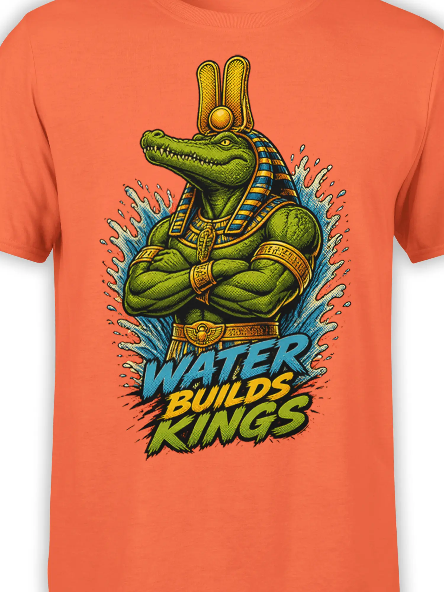 Close-up of green crocodile king artwork, Egyptian headdress, water splash, and bold lettering on an orange shirt
