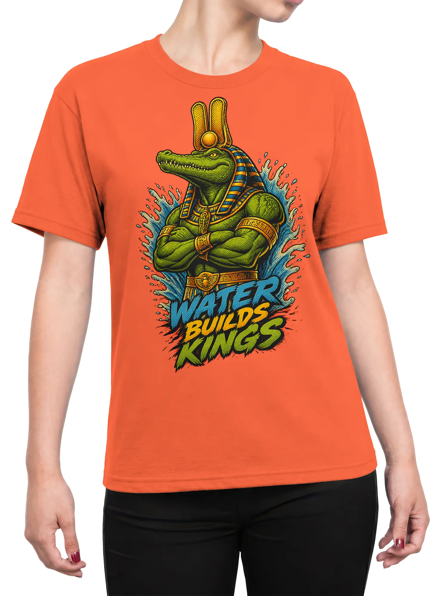 Female torso wearing an orange T-shirt with a green Egyptian crocodile king and “Water Builds Kings” design