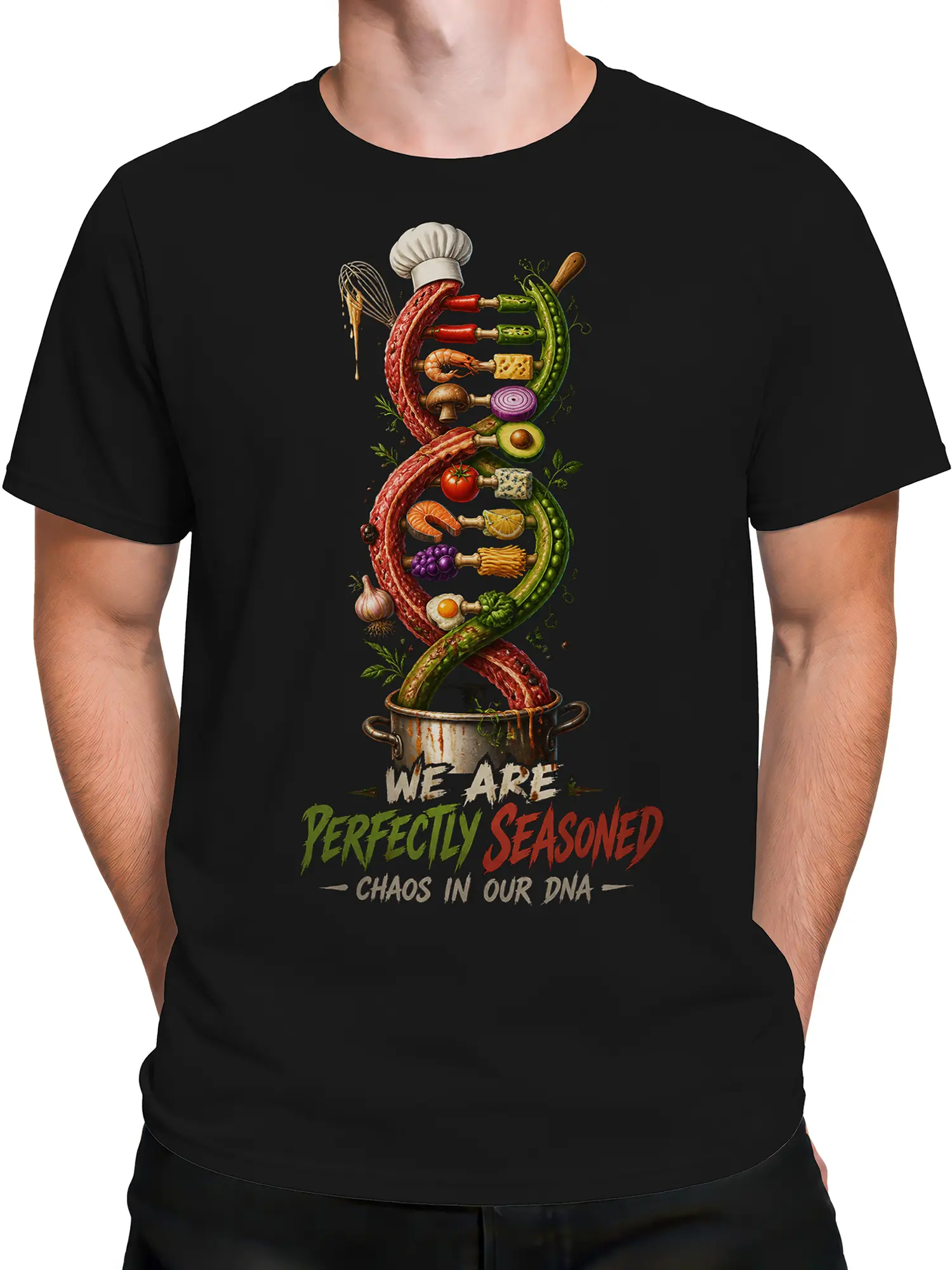 Male torso wearing a black culinary graphic tee with food DNA artwork, chef details, and seasoning slogan