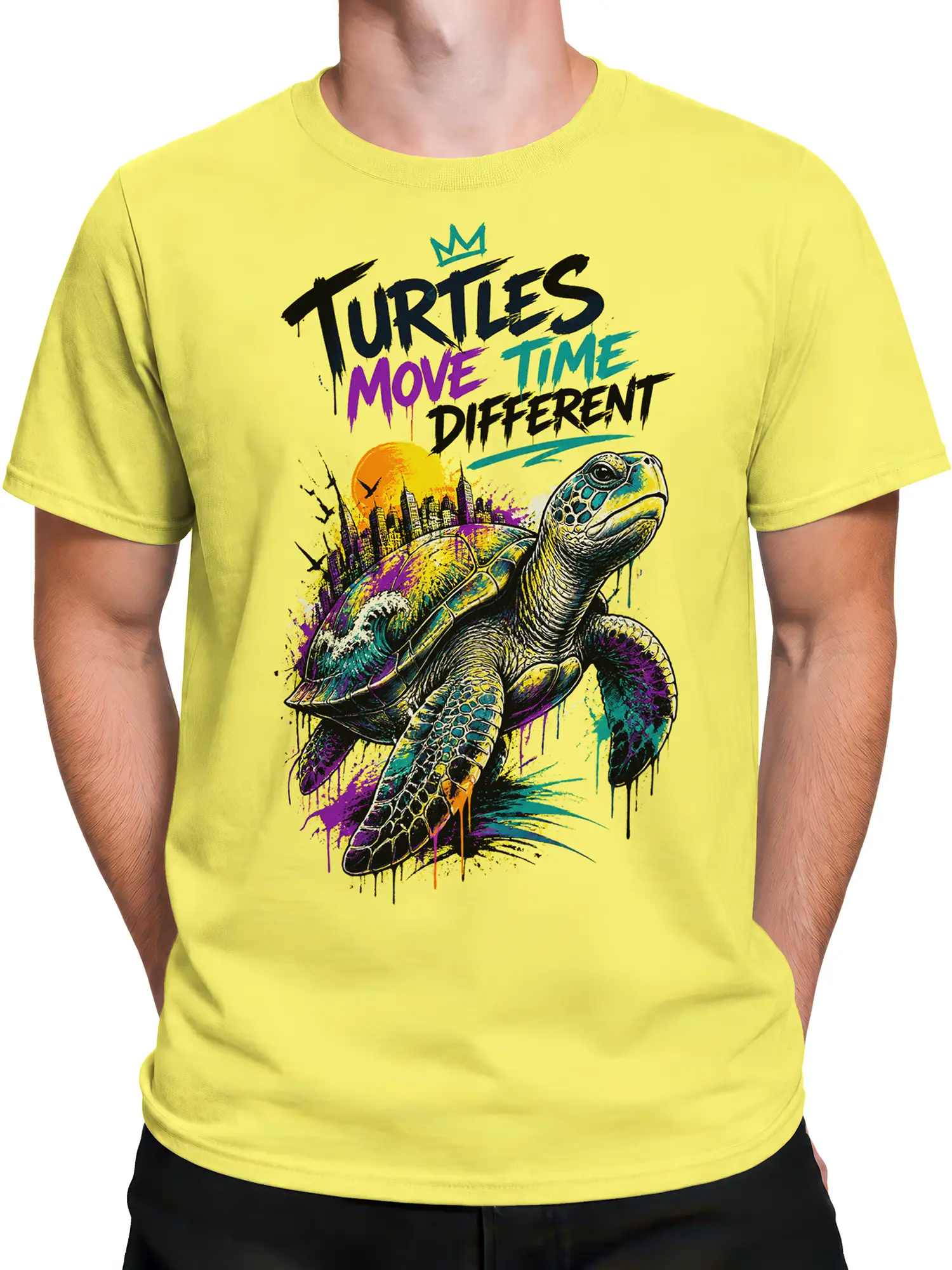 Male torso wearing a yellow graphic tee with a colorful turtle, skyline, sunset, and expressive lettering