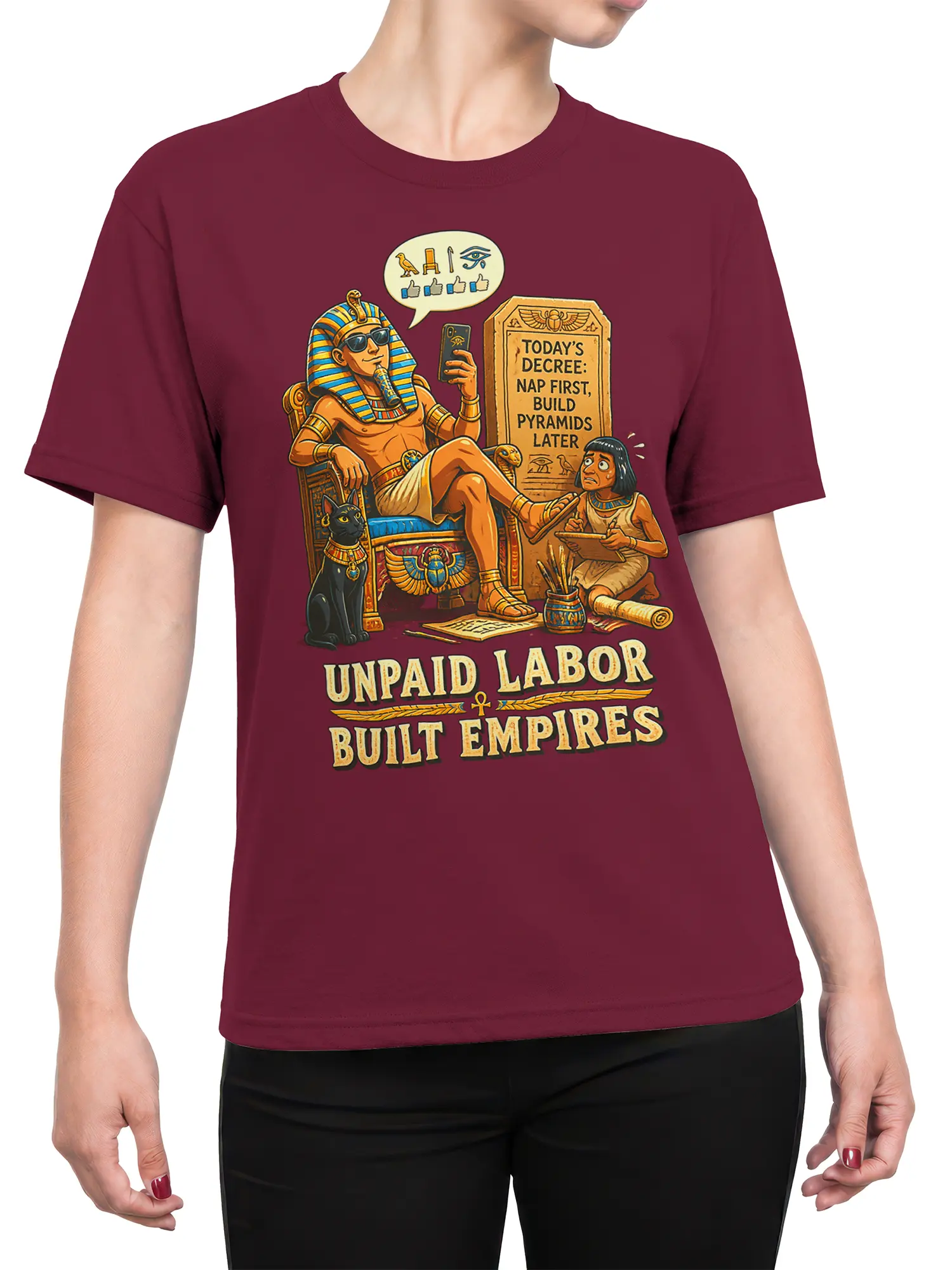 Female torso wearing a burgundy ancient Egypt T-shirt with pharaoh, black cat, and unpaid labor artwork