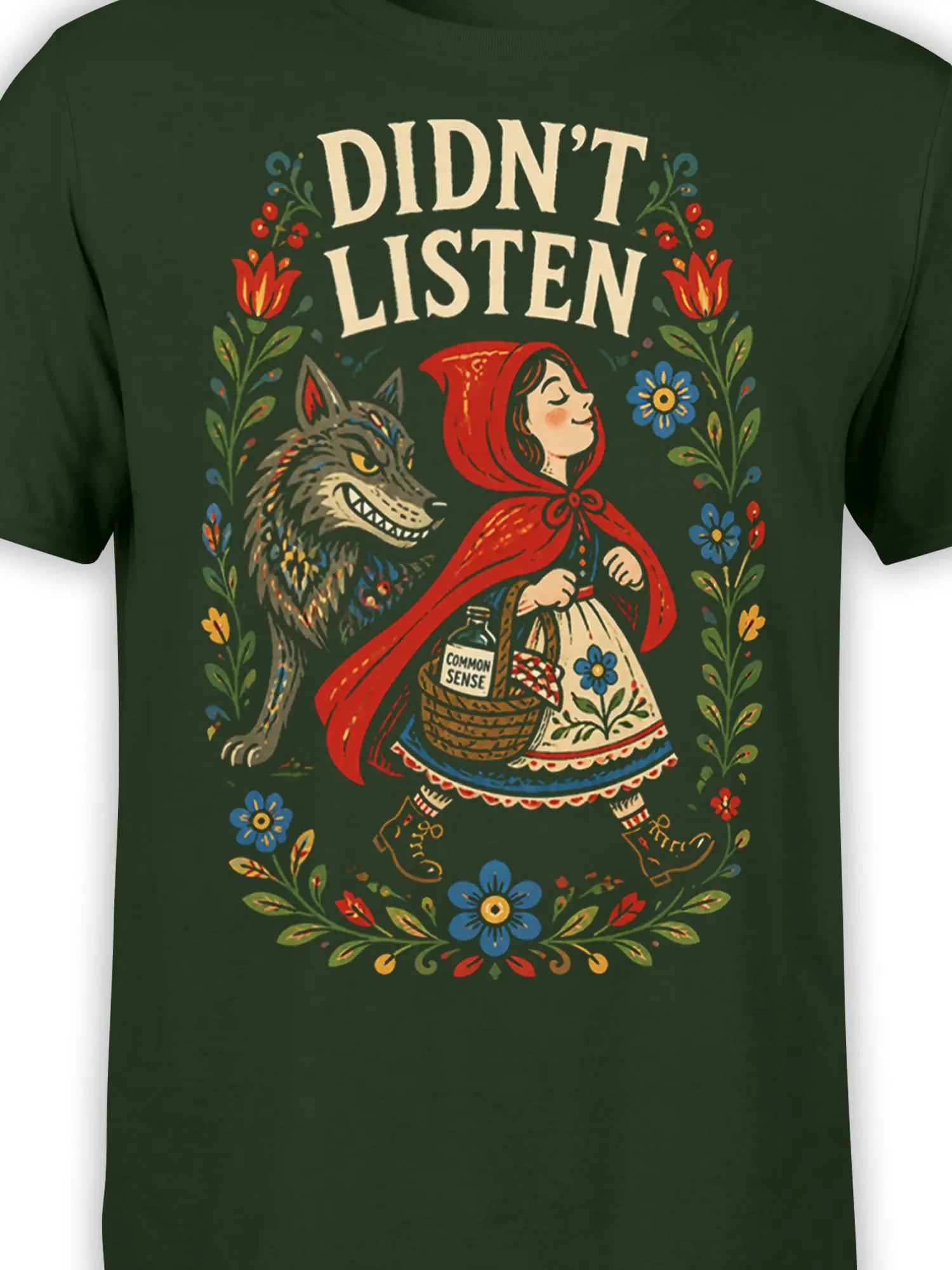 Close-up of red-hooded girl and grinning wolf in colorful vintage storybook artwork on a green T-shirt