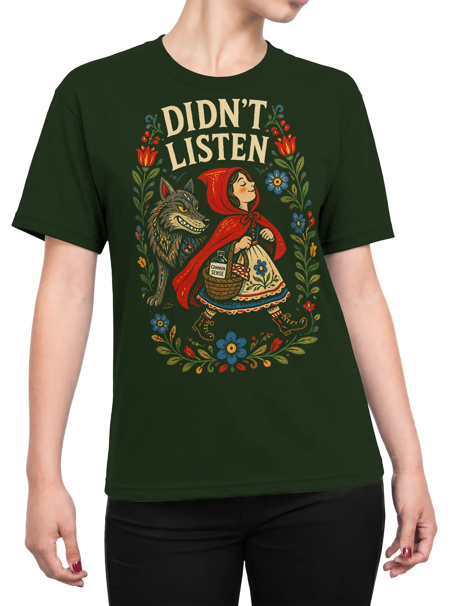 Female torso wearing a green T-shirt with red hood, wolf, flowers, and “DIDN’T LISTEN” vintage artwork