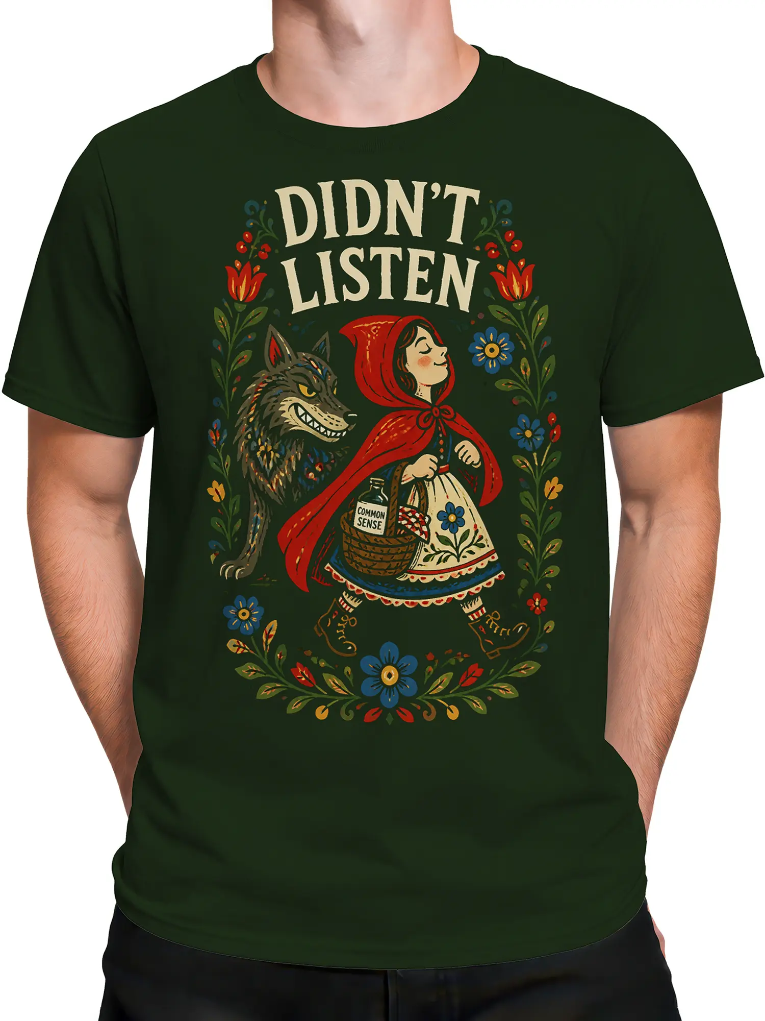 Male torso wearing a green vintage wolf T-shirt with red-hooded girl and colorful floral artwork
