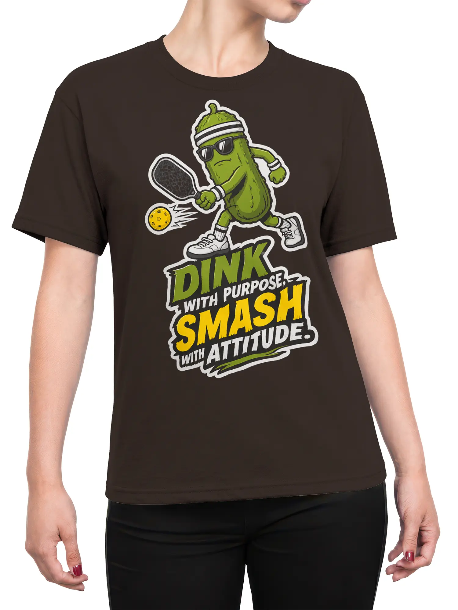 Female torso wearing a brown pickleball T-shirt with a green pickle player and colorful court attitude design