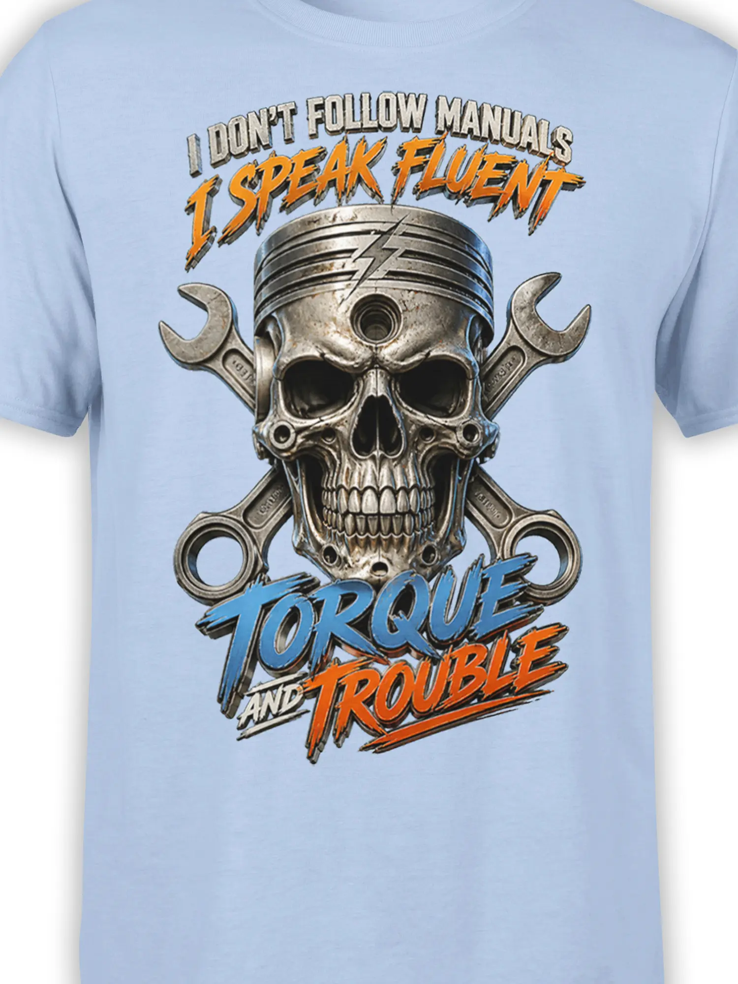 Close-up of piston skull and crossed wrench artwork with orange and blue torque lettering on a light blue shirt