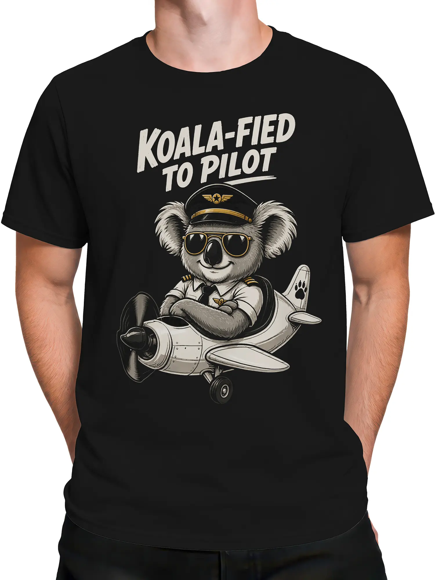 Male torso wearing a black koala pilot T-shirt with retro airplane artwork and “KOALA-FIED TO PILOT” text