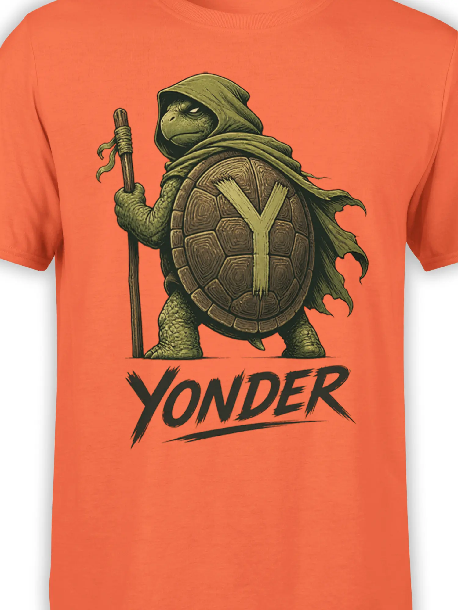 Close-up of turtle warrior artwork, shell armor, cloak, staff, and YONDER text on orange fabric