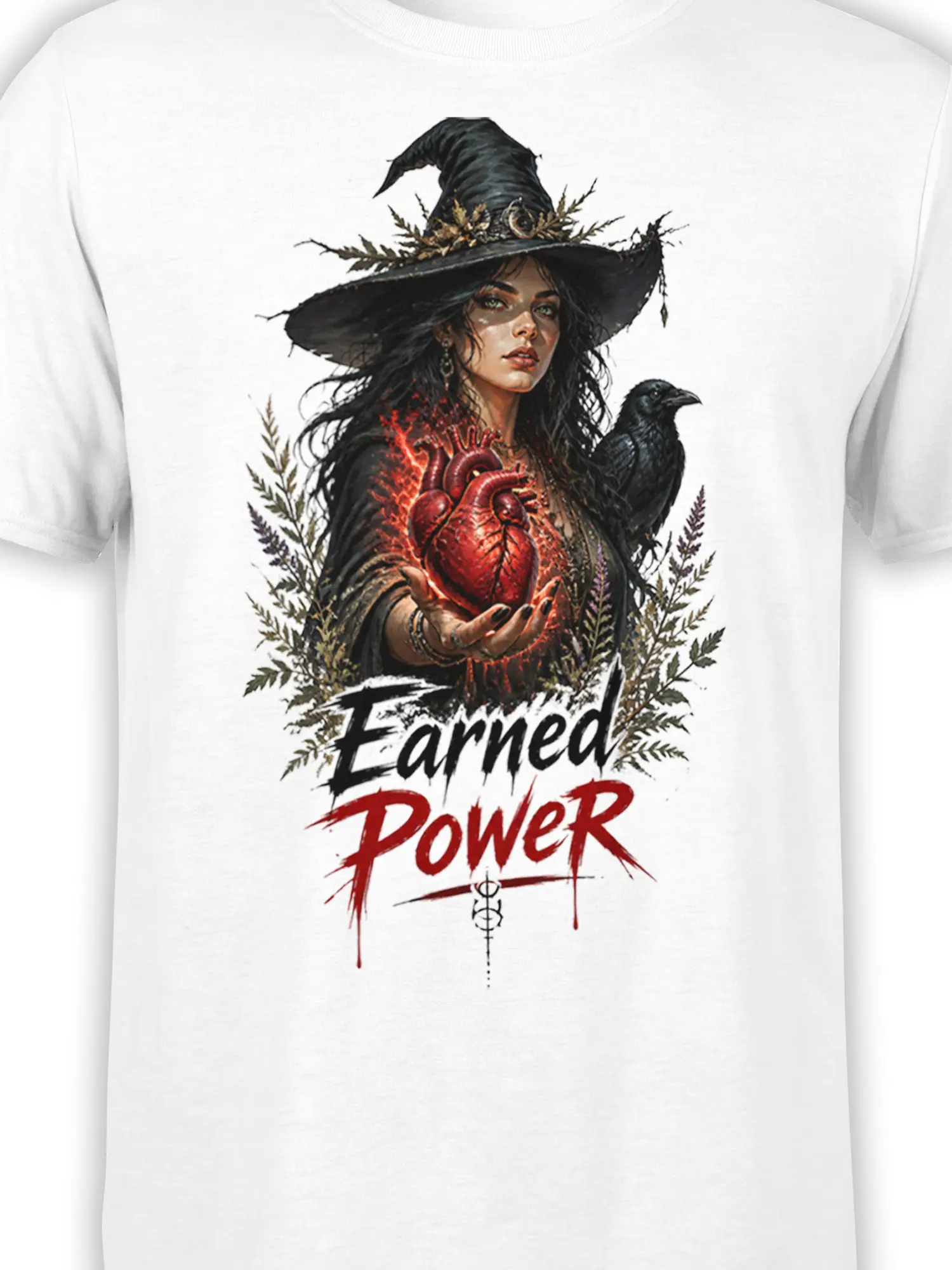 Close-up of witch, raven, glowing heart, botanical details, and “Earned Power” design on white fabric