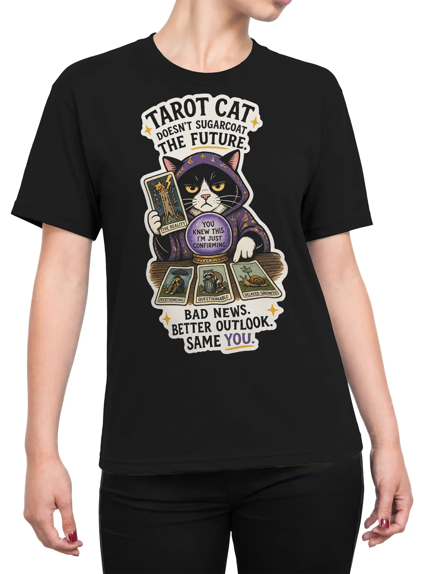 Female torso wearing a black T-shirt with hooded cat tarot artwork, crystal ball, and illustrated cards