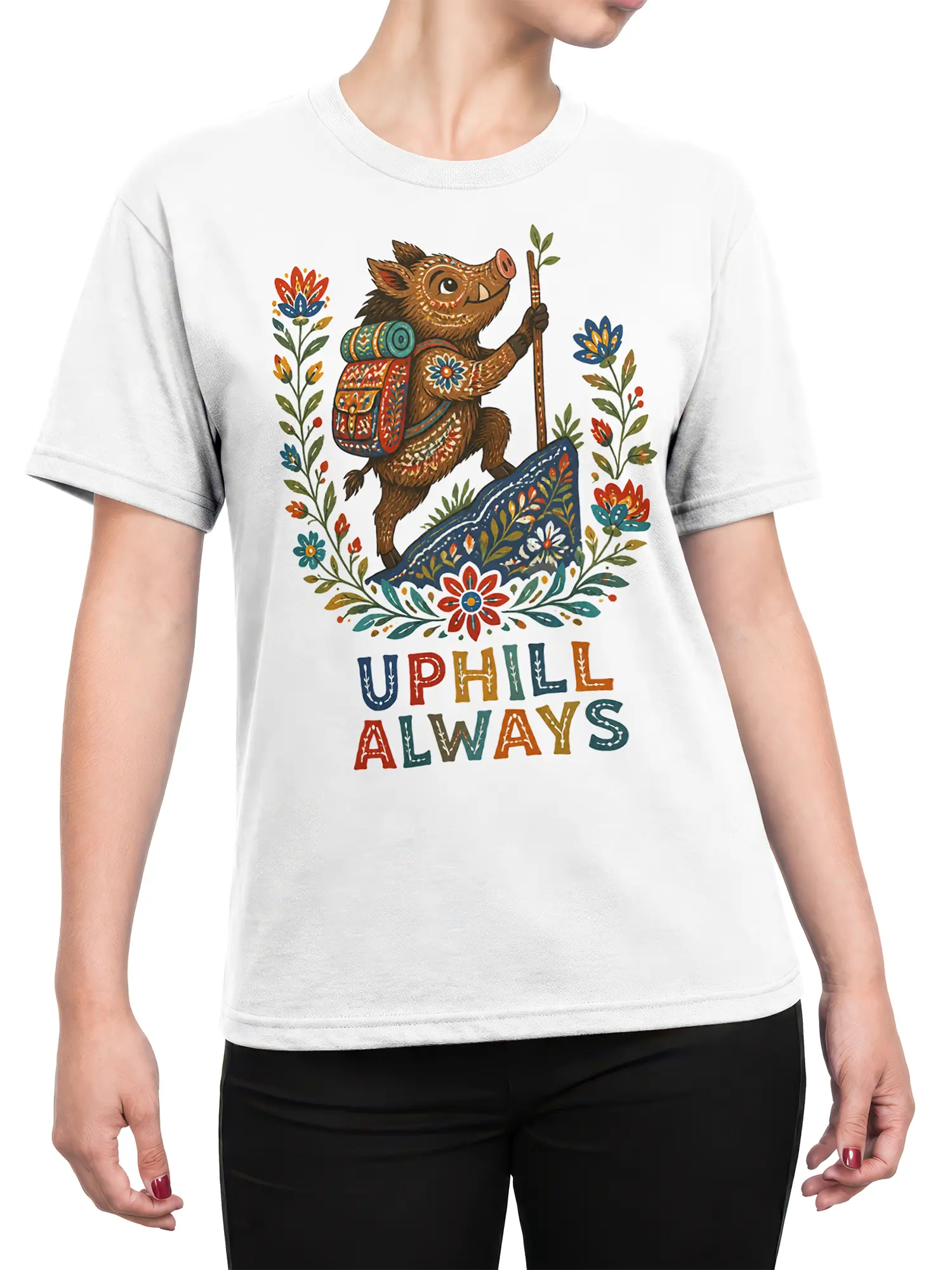 Female torso wearing a white boar hiking T-shirt with colorful folk-art flowers and UPHILL ALWAYS lettering