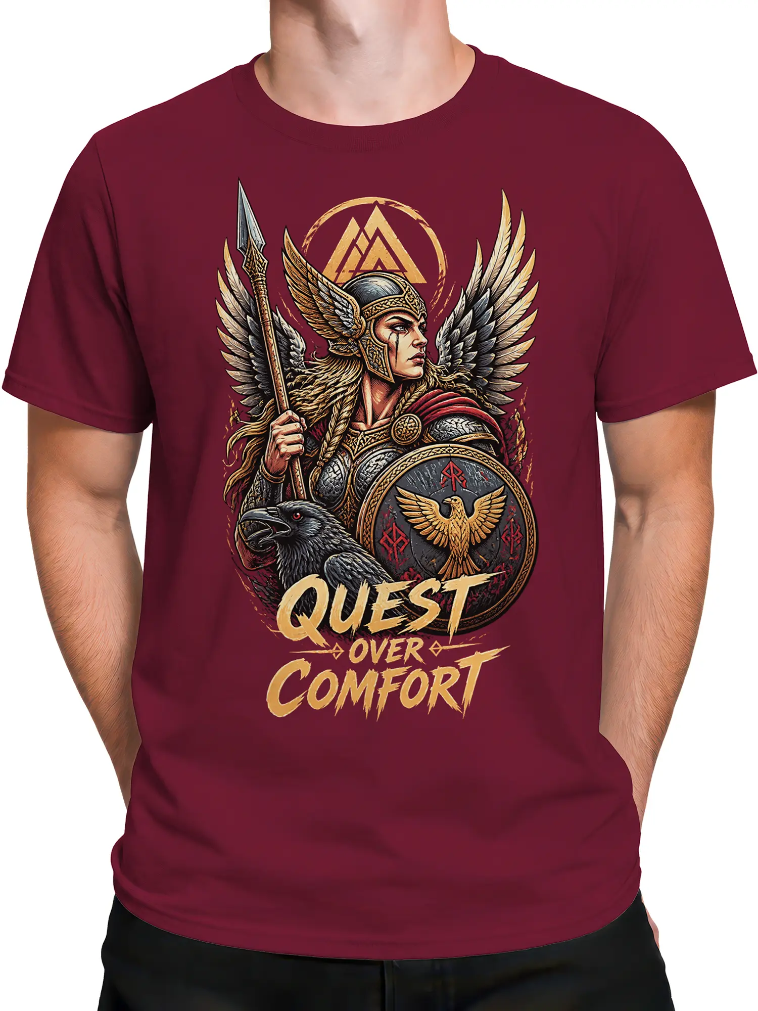 Male torso wearing a burgundy winged warrior T-shirt with raven, eagle shield, and “Quest Over Comfort” design