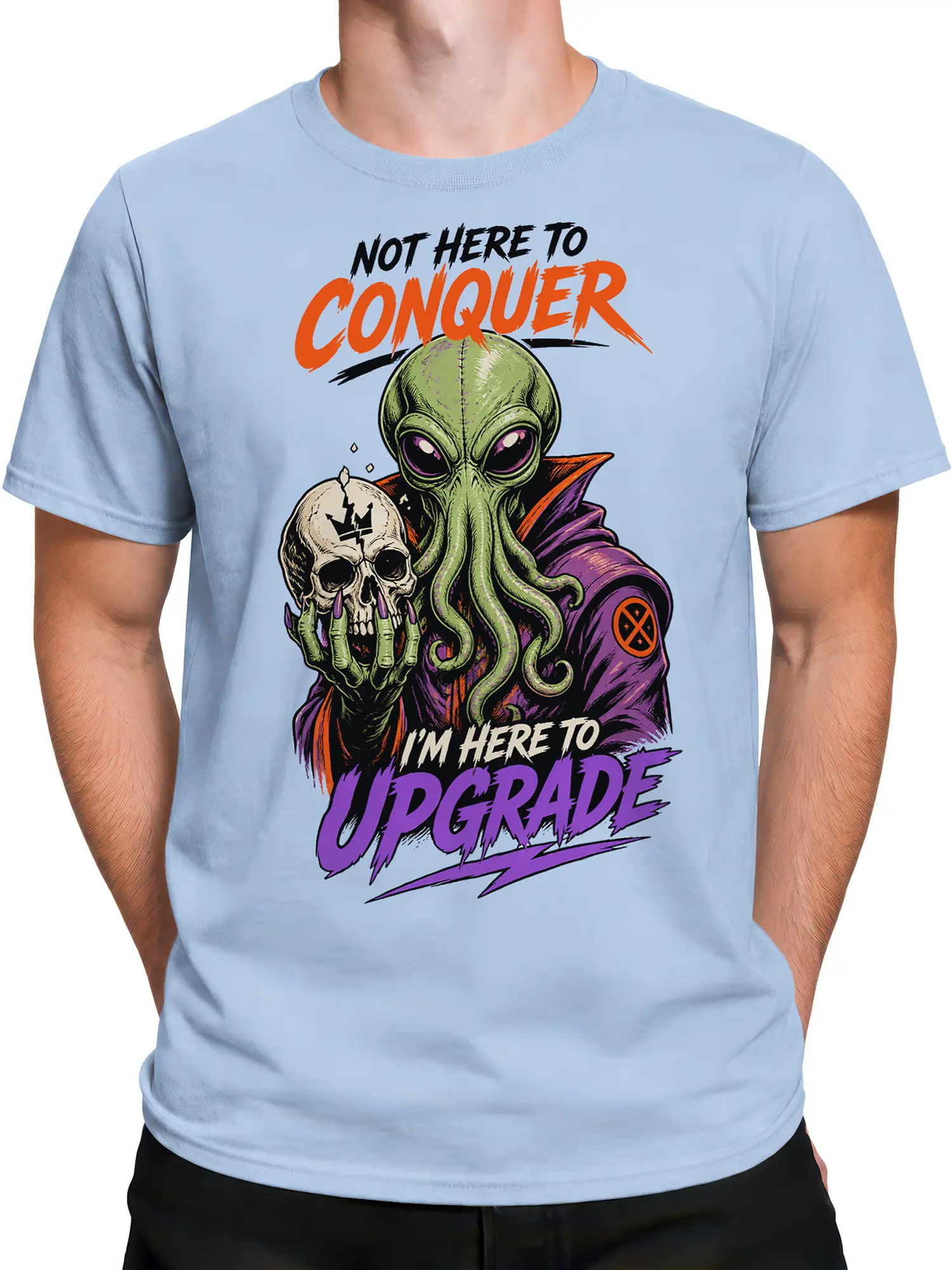Male torso wearing a light blue alien t-shirt with colorful skull artwork and bold upgrade text