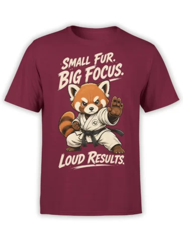 Focused red panda in a martial arts uniform on a burgundy T-shirt with bold motivational lettering