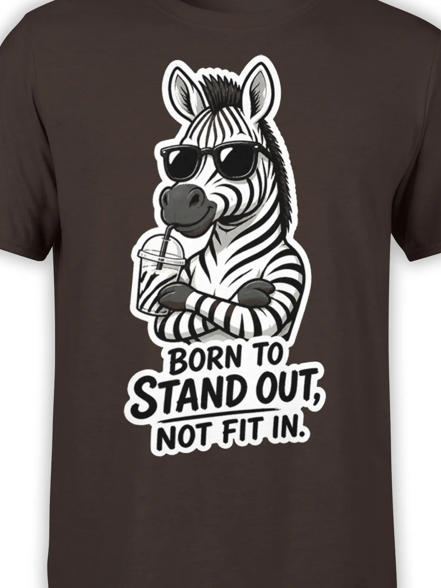 Close-up of zebra sunglasses and bold Born to Stand Out graphic on a brown T-shirt