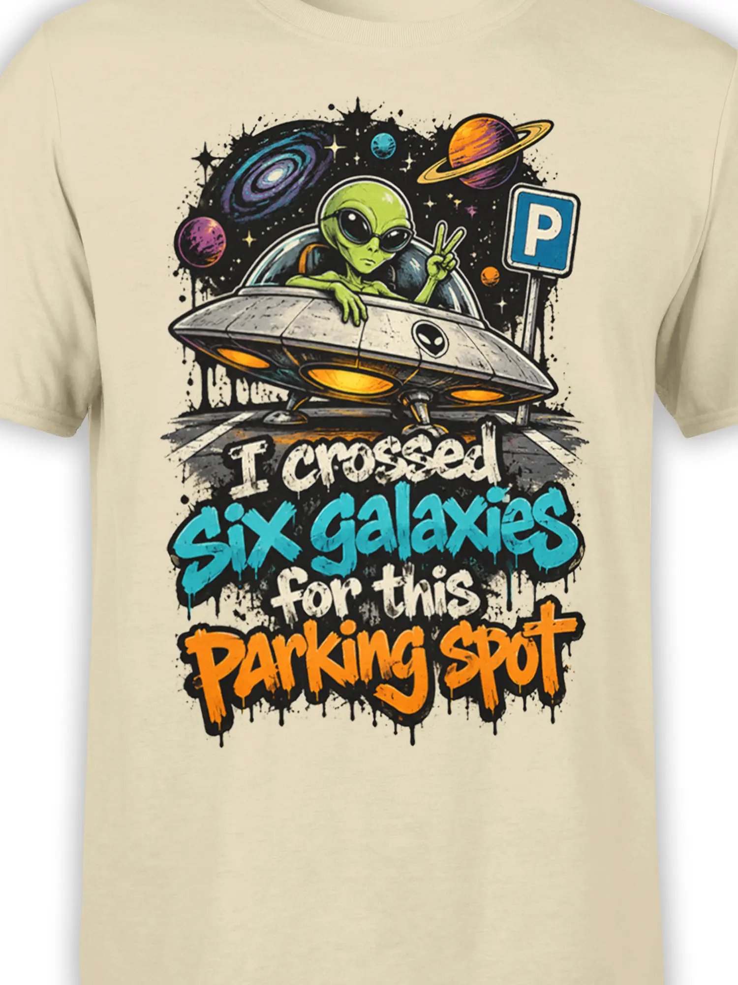 Close-up of green alien pilot, flying saucer, planets, and colorful parking joke artwork on beige fabric