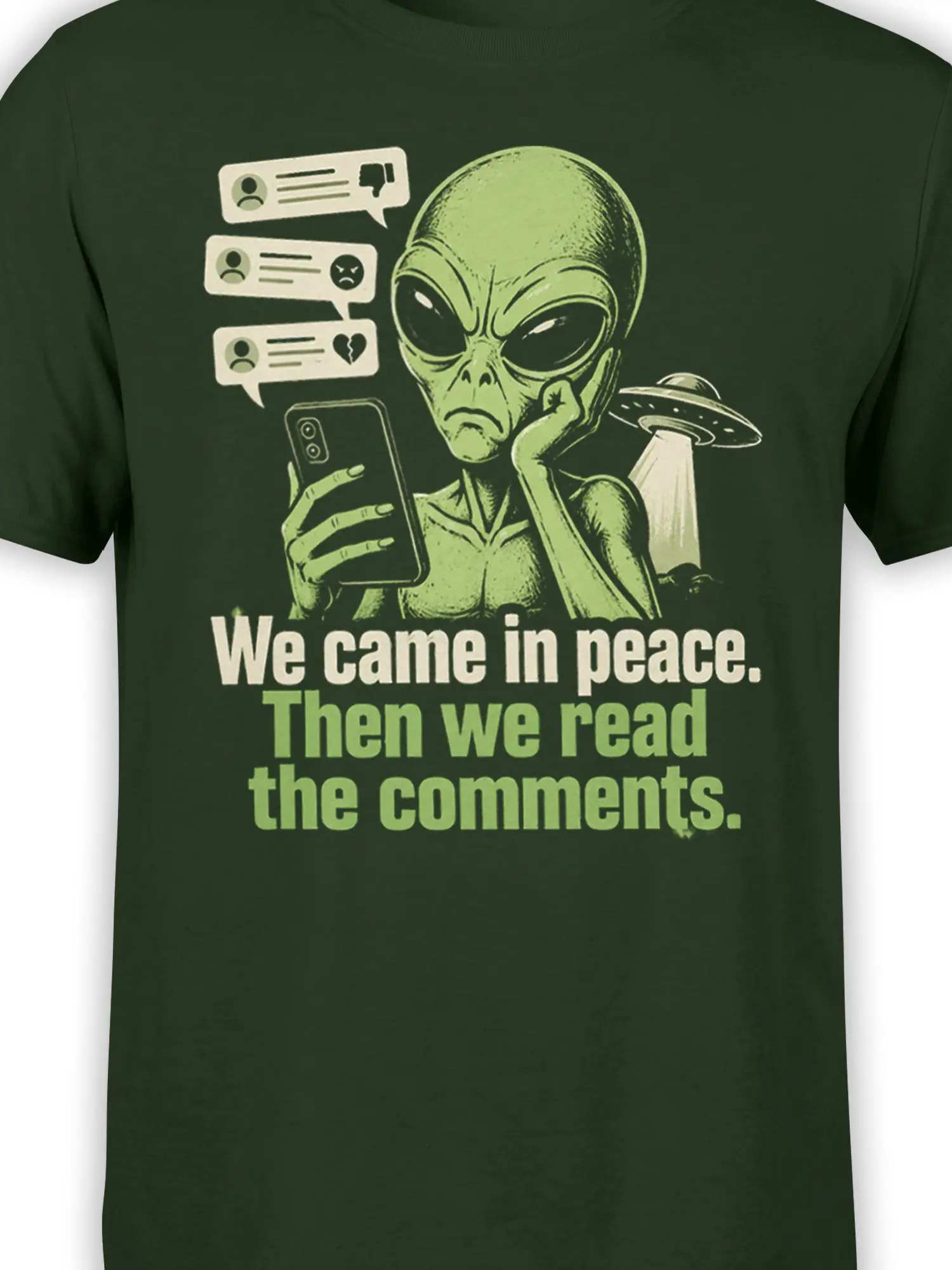 Close-up of green alien artwork reading angry comments on a graphic T-shirt