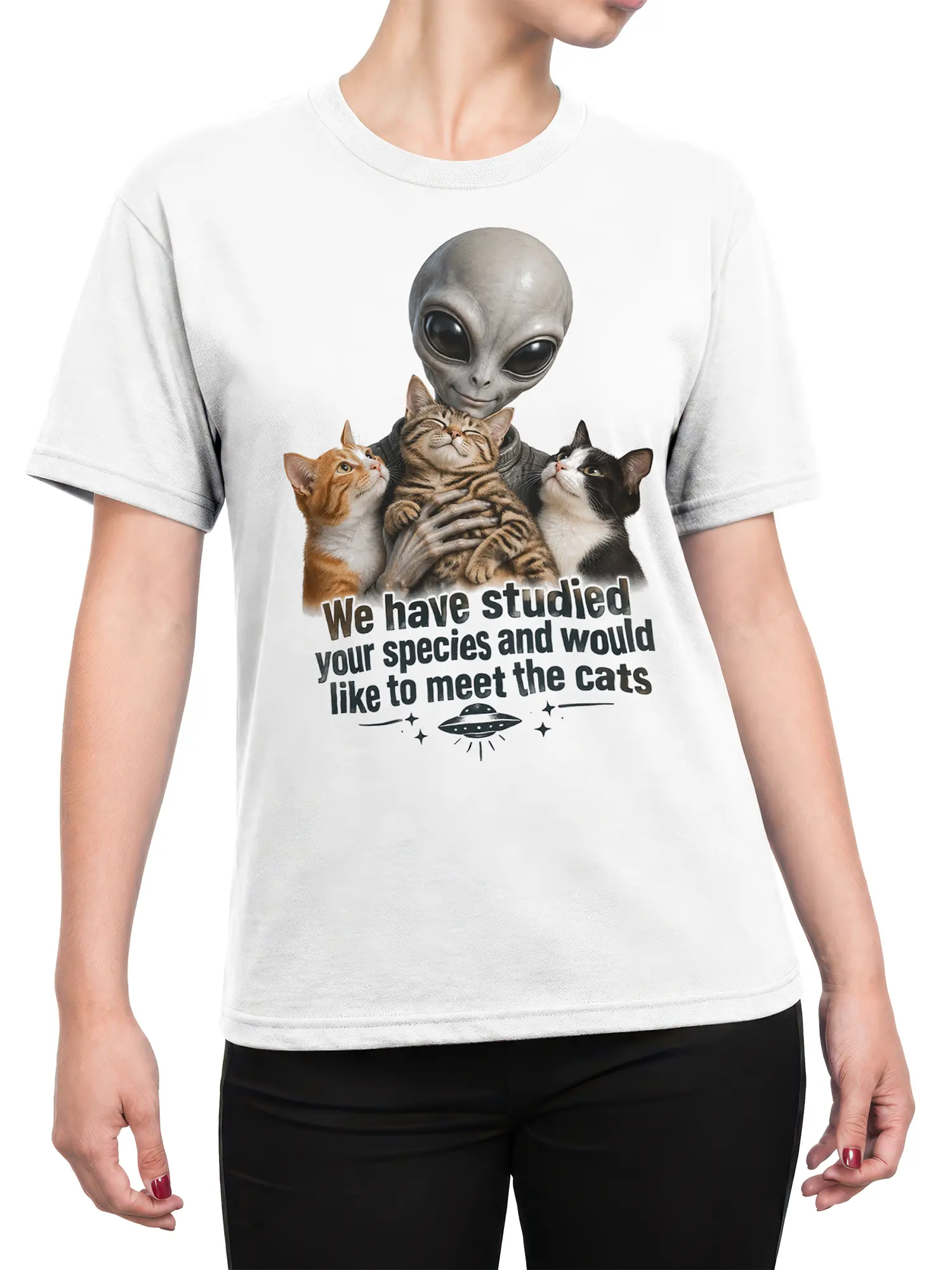 Female torso wearing a white alien cat T-shirt with three cats and a UFO graphic
