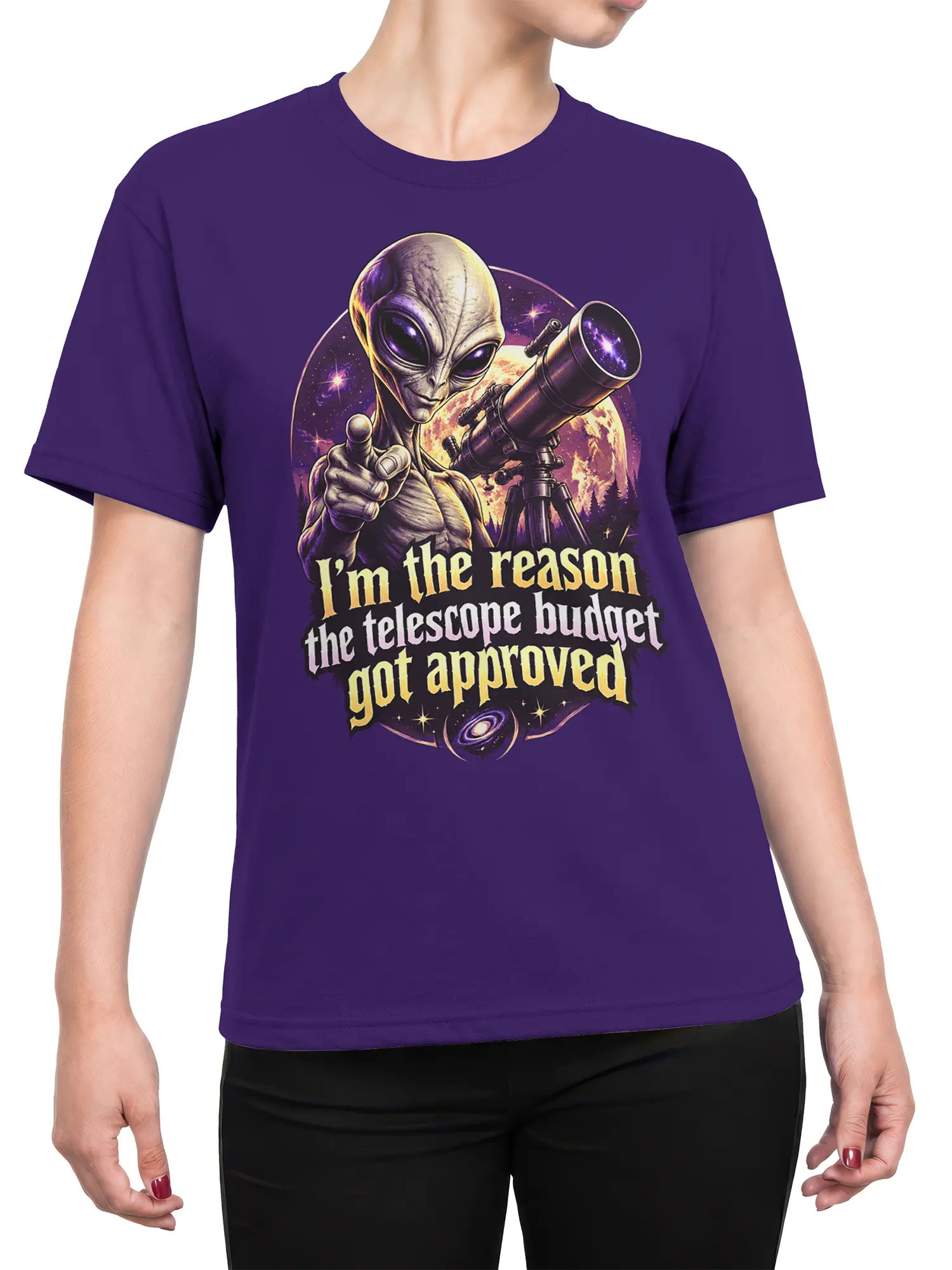 Female torso wearing a purple alien telescope T-shirt with cosmic artwork and humorous budget lettering