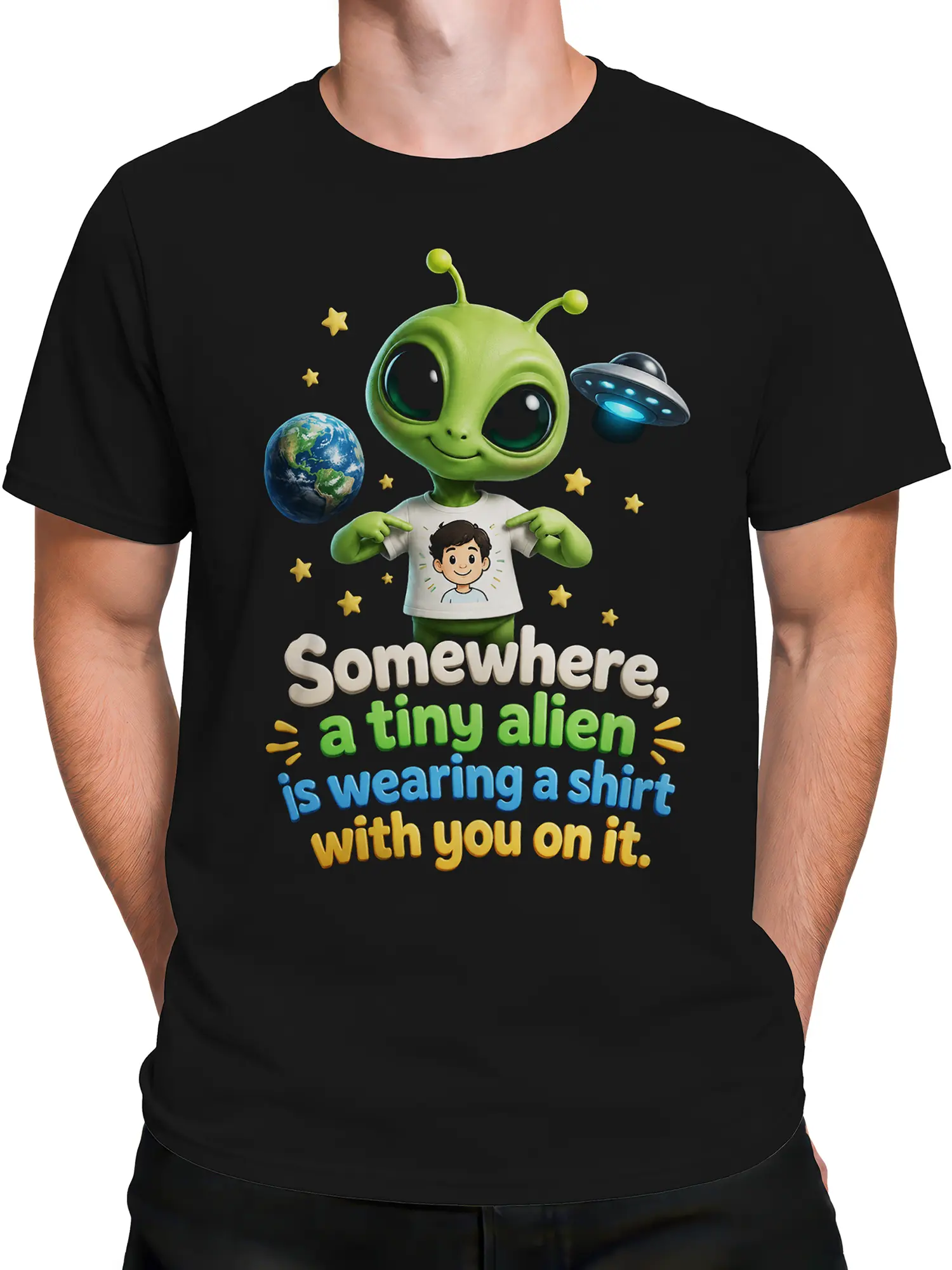 Male torso wearing a black alien T-shirt with Earth, flying saucer, stars, and playful colorful text