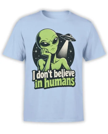 Green skeptical alien and flying saucer graphic with “I don’t believe in humans” on a light blue shirt