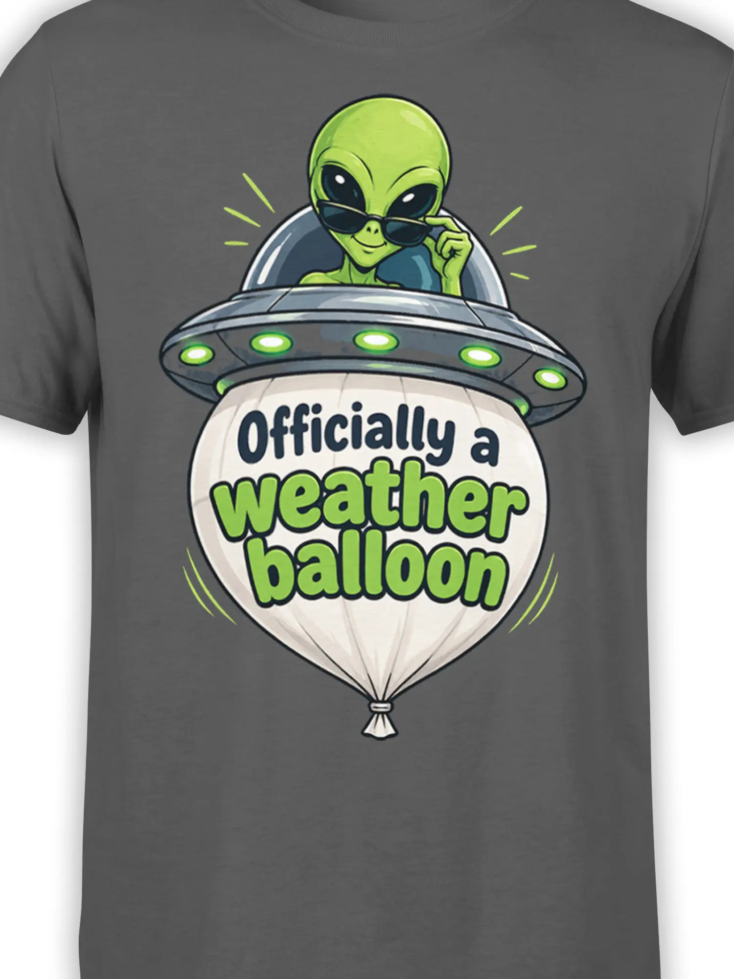 Close-up of the green alien, sunglasses, flying saucer, and weather balloon design on a gray T-shirt
