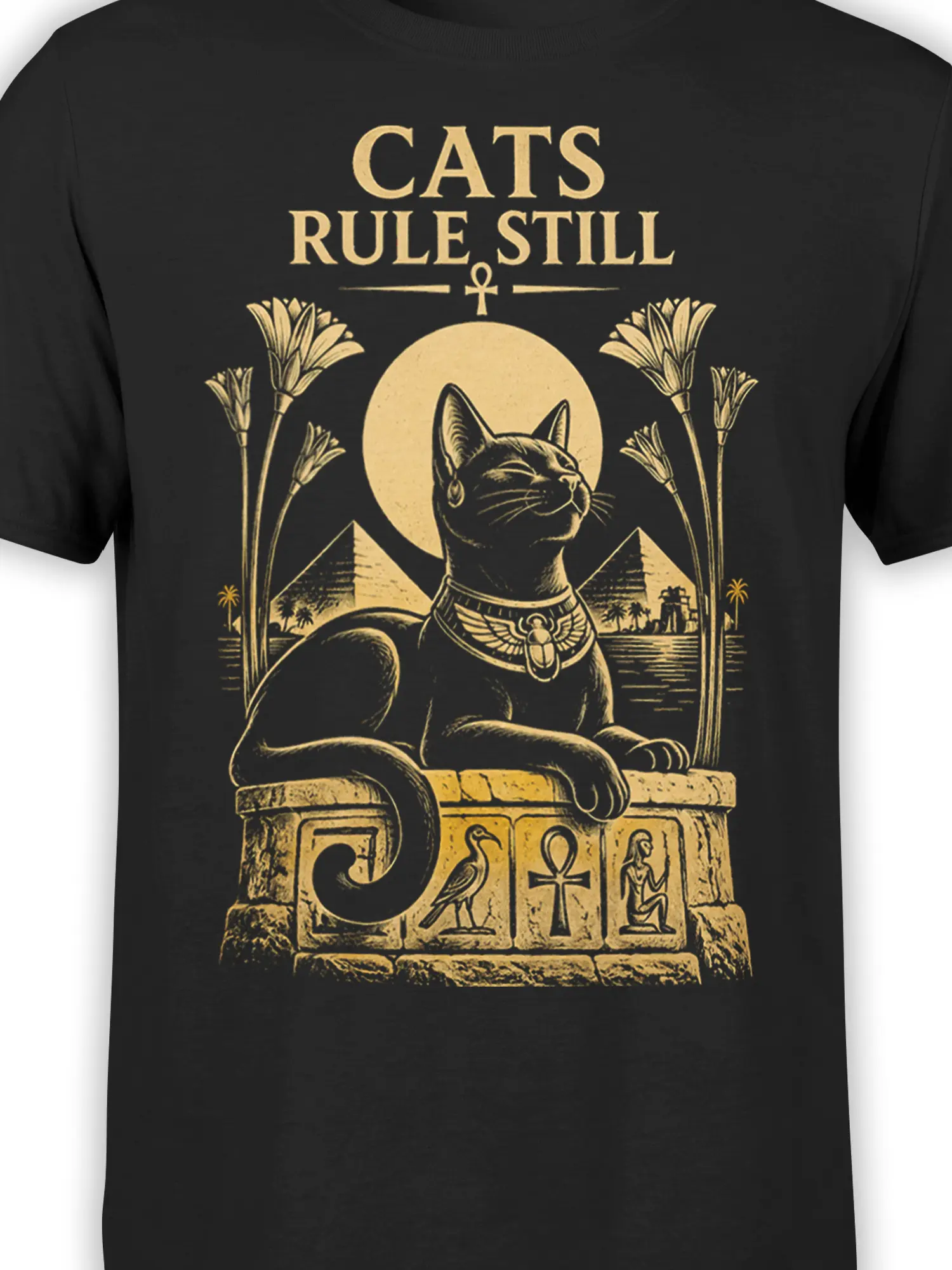 Close-up of golden Egyptian cat graphic with ankh, pyramids, temple symbols, and vintage “CATS RULE STILL” lettering