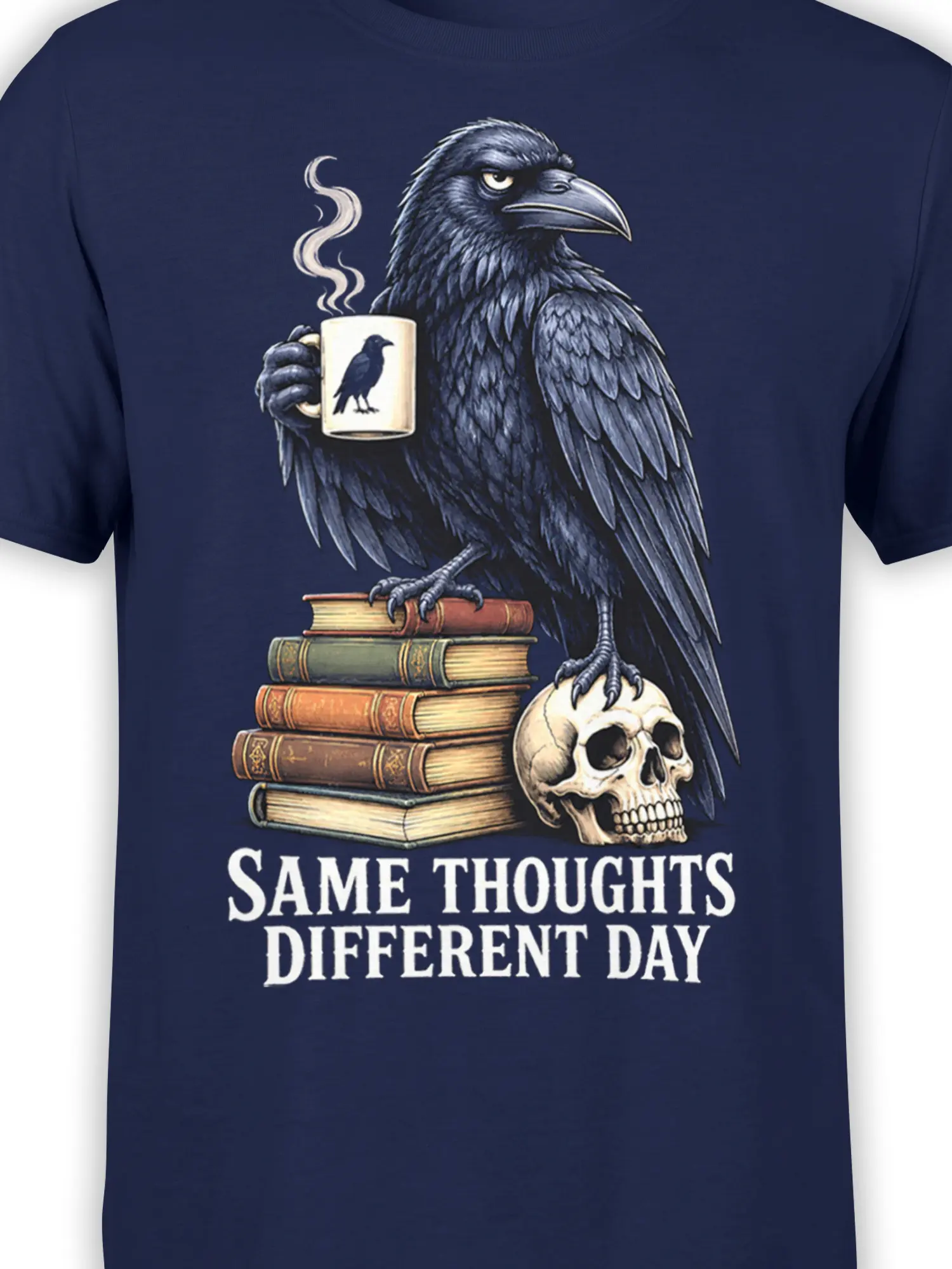 Close-up of raven, coffee mug, vintage books, skull, and quote artwork on a navy graphic T-shirt