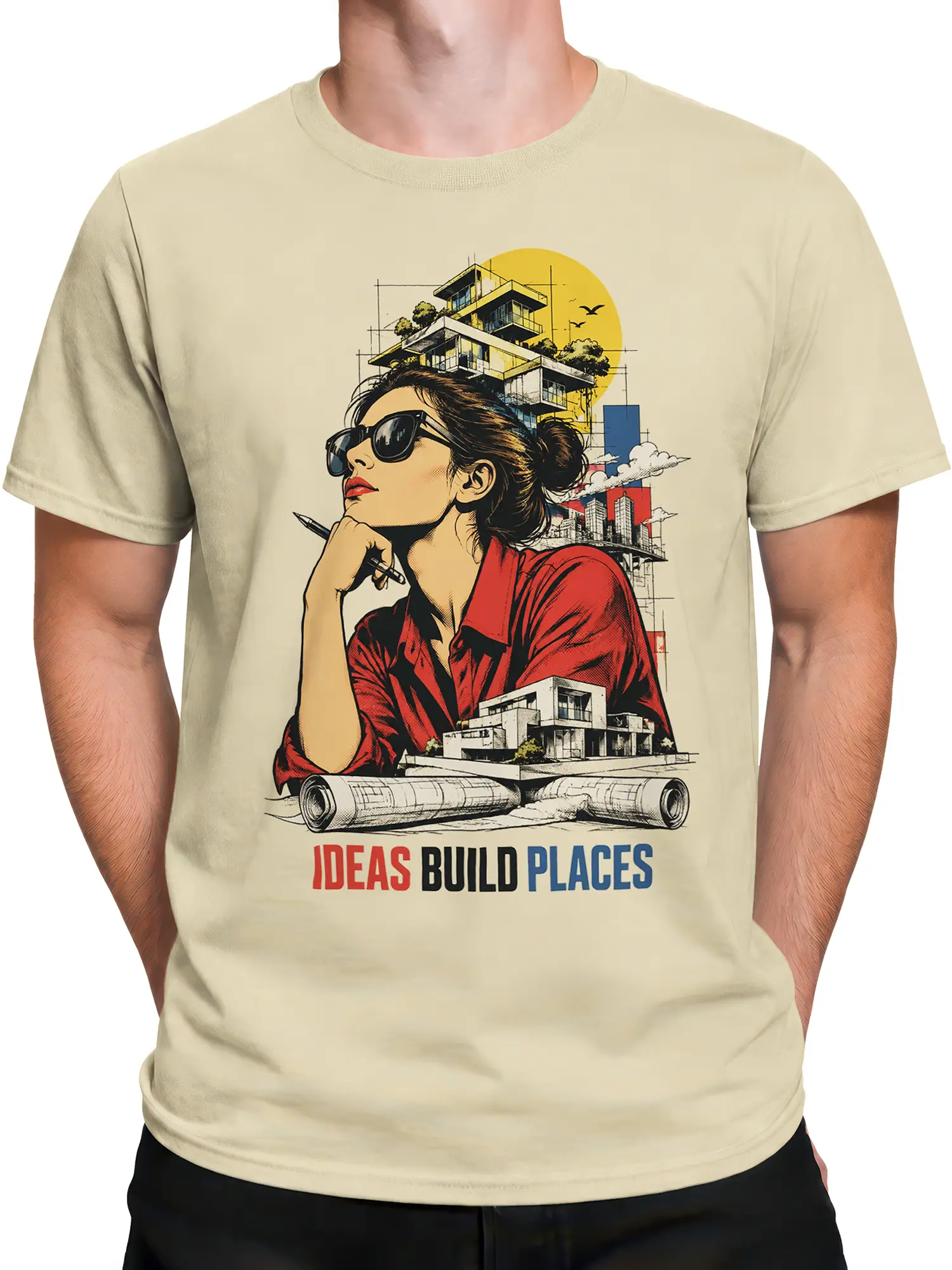 Male torso wearing beige architect T-shirt with blueprints, modern buildings, and Ideas Build Places artwork
