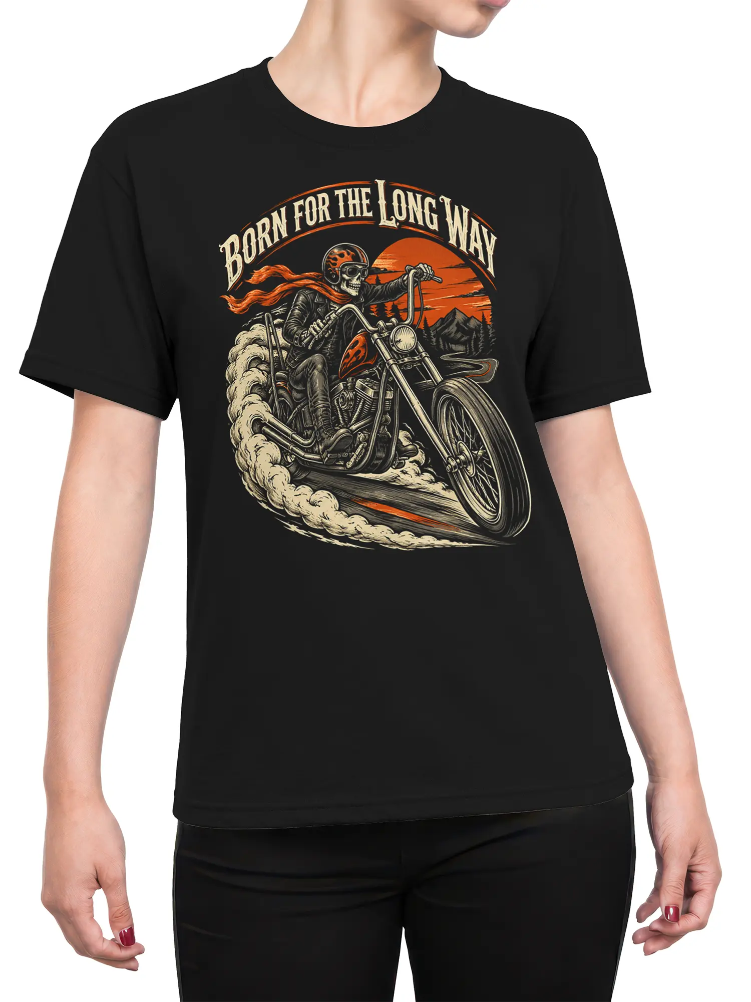 Female torso wearing a black motorcycle T-shirt with a vintage skeleton biker, desert road, mountains, and orange sunset graphic