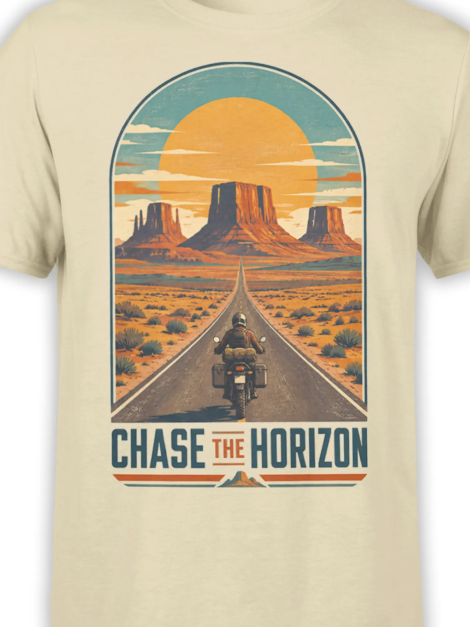 Close-up of the beige T-shirt design showing a motorcyclist, desert road, mesas, orange sun, and CHASE THE HORIZON text