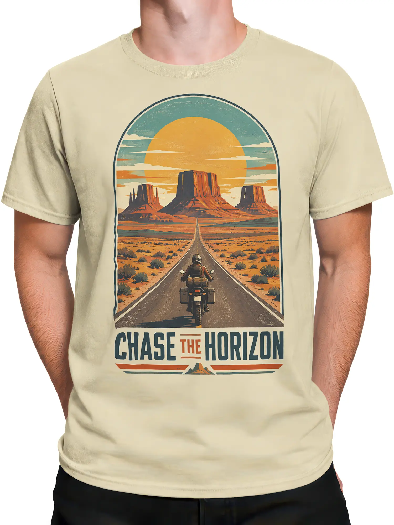 Male torso wearing a beige T-shirt with a retro desert highway, motorcyclist, mesas, orange sun, and horizon message