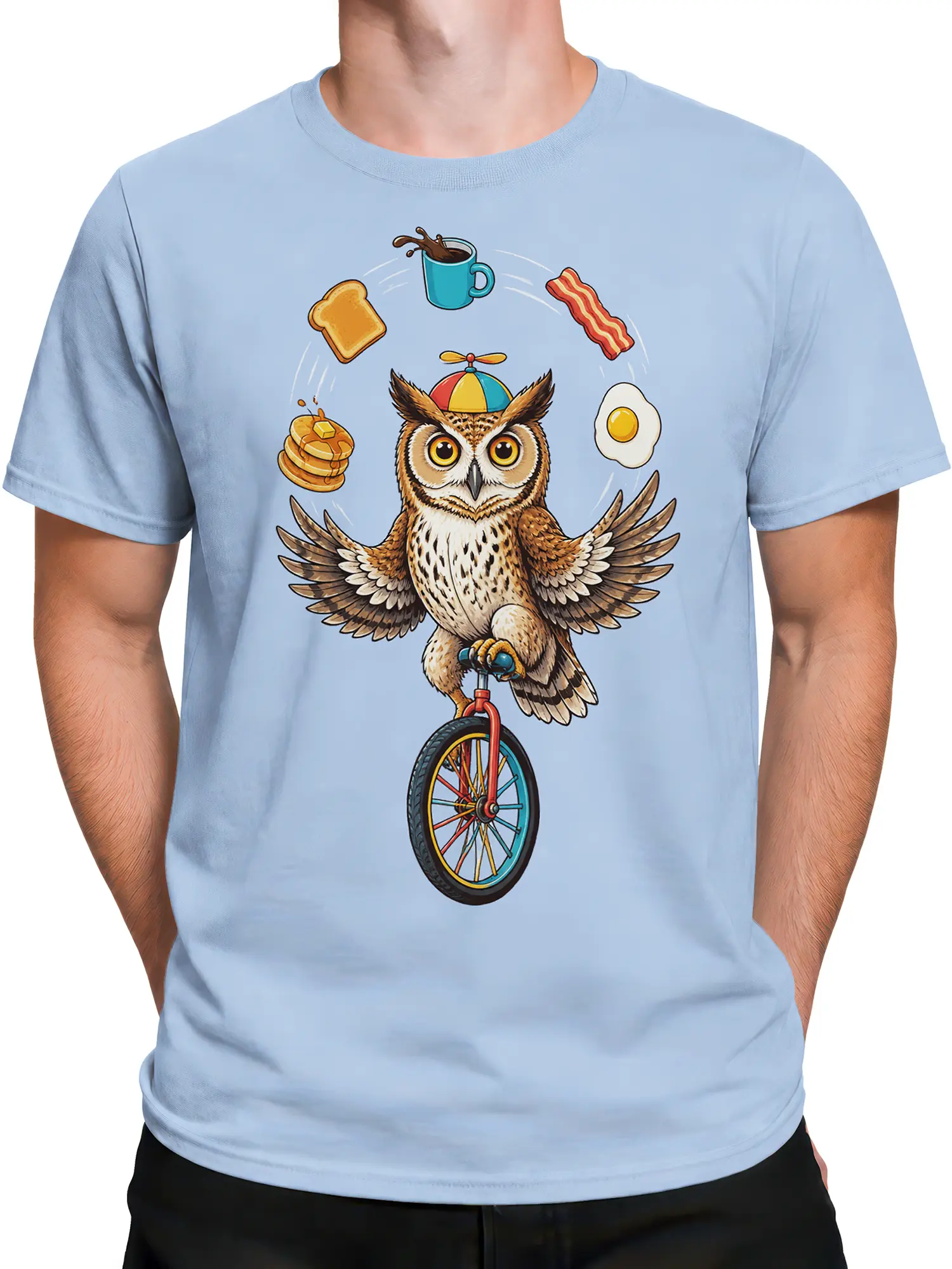 Male torso wearing a light blue shirt with a balancing owl and breakfast food graphic