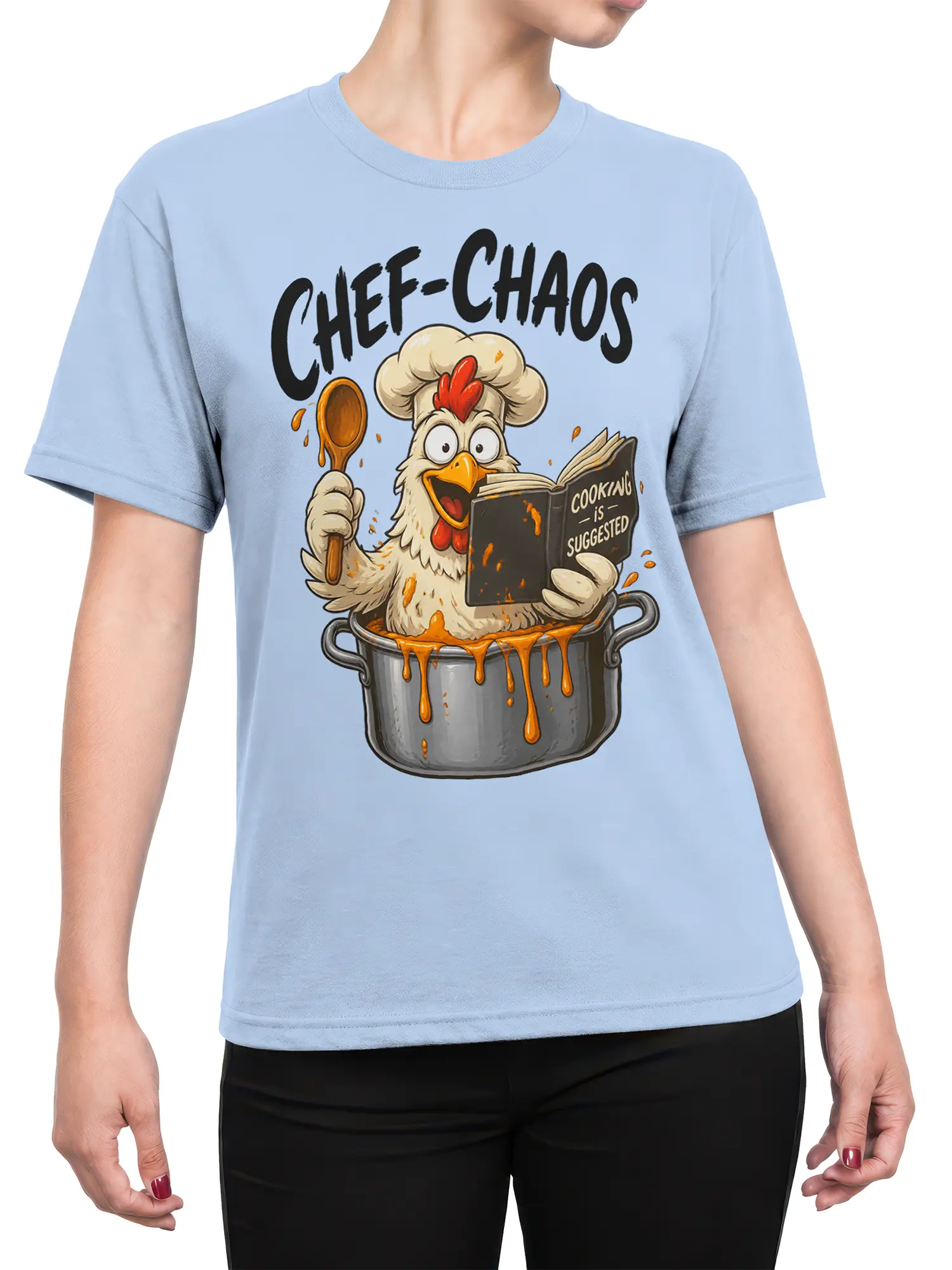 Female torso wearing a light blue chicken chef graphic tee with a spoon, recipe book, and kitchen chaos artwork
