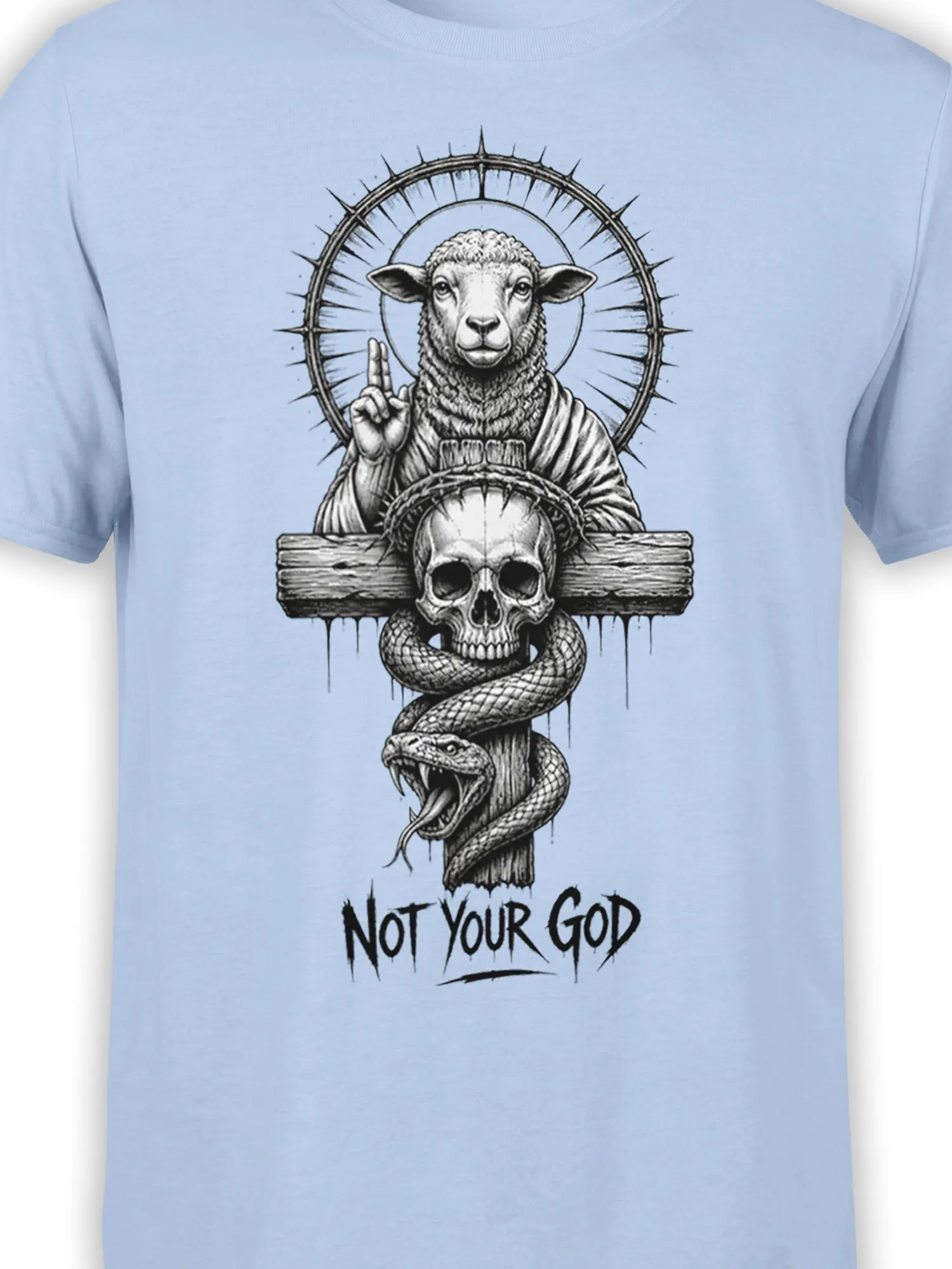 Close-up of sheep, thorn halo, skull, snake, and “Not Your God” design on light blue fabric